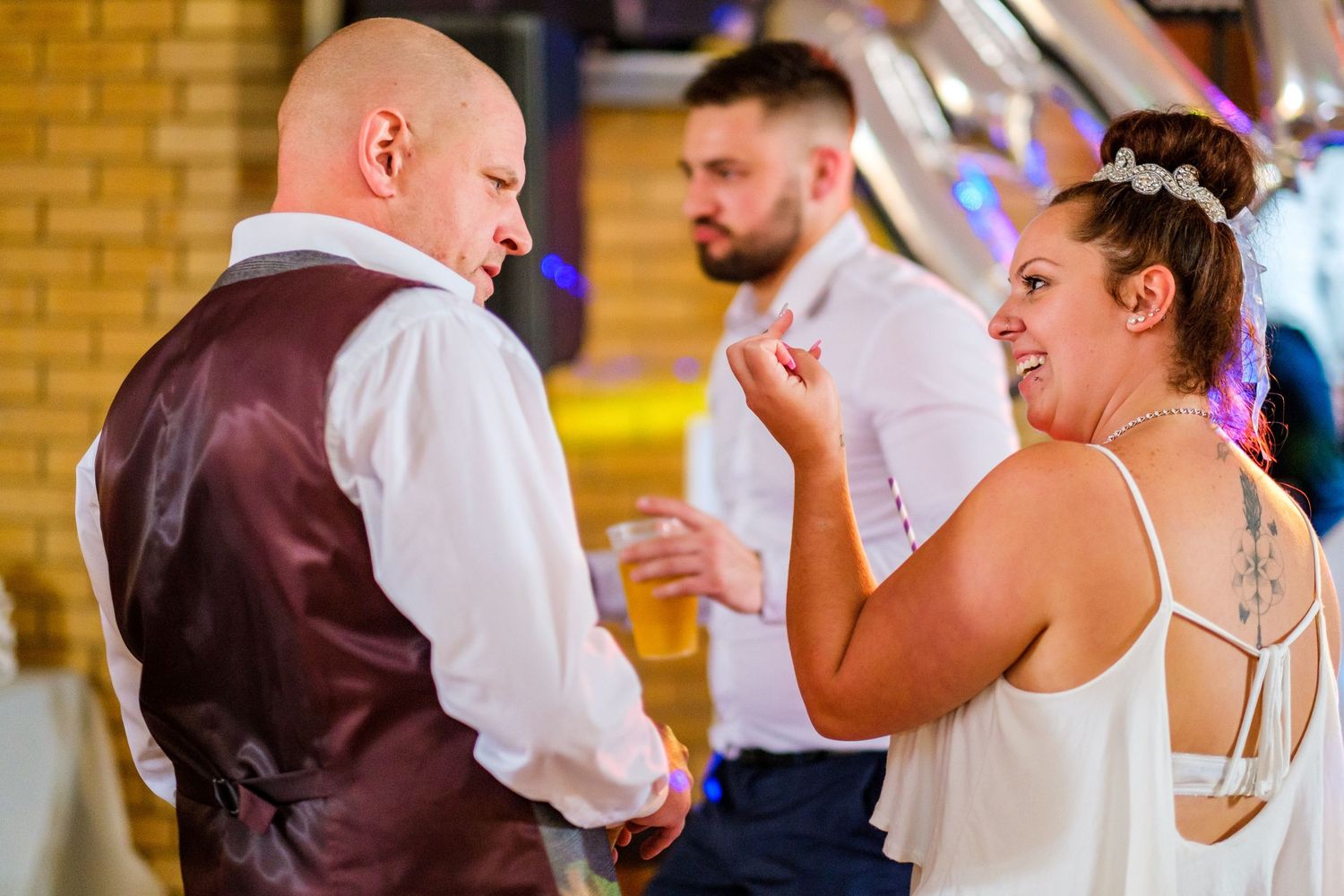 Wedding reception guests dancing and celebrating on the dance floor.