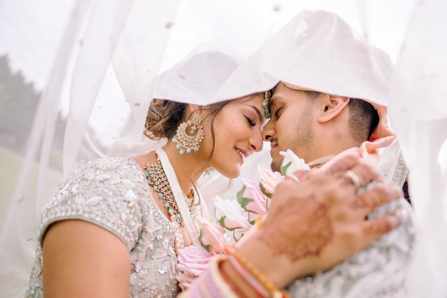 Romantic close-up shot of a couple embracing during their wedding celebration.