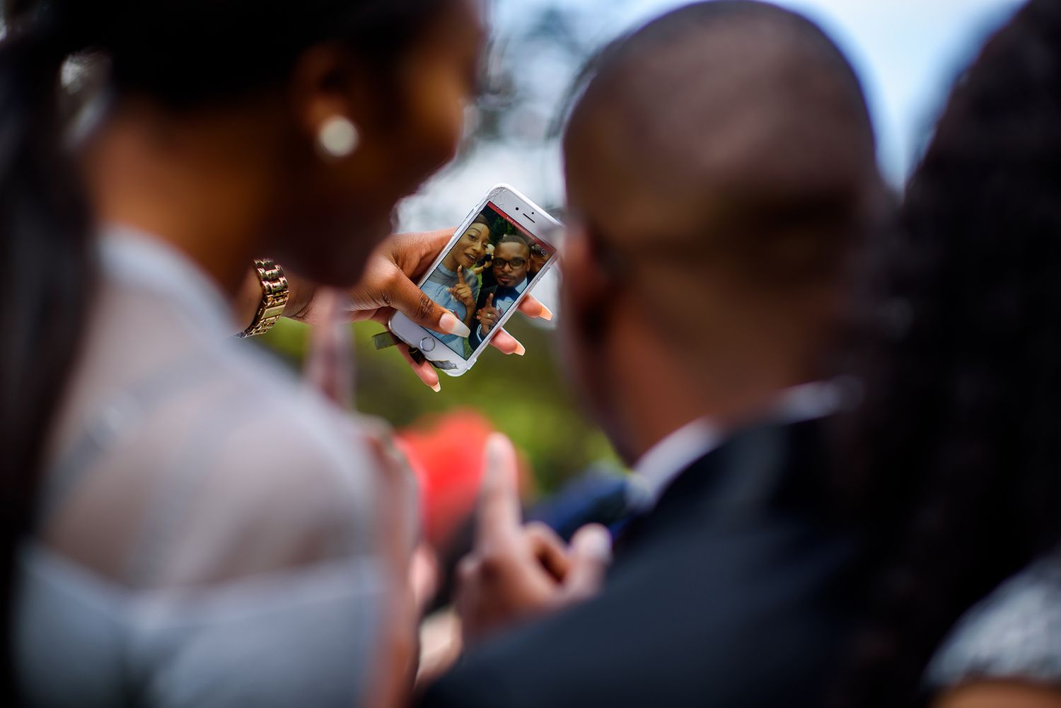 Close-up shots of guests celebrating and enjoying refreshments at outdoor reception.