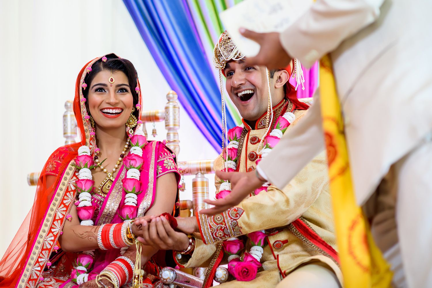Traditional Indian wedding ceremony with couple in ornate ceremonial dress.