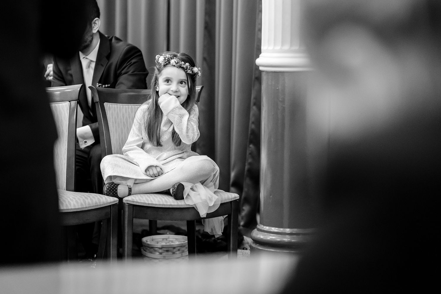 Wedding reception moments captured in black and white showing guests interacting indoors.
