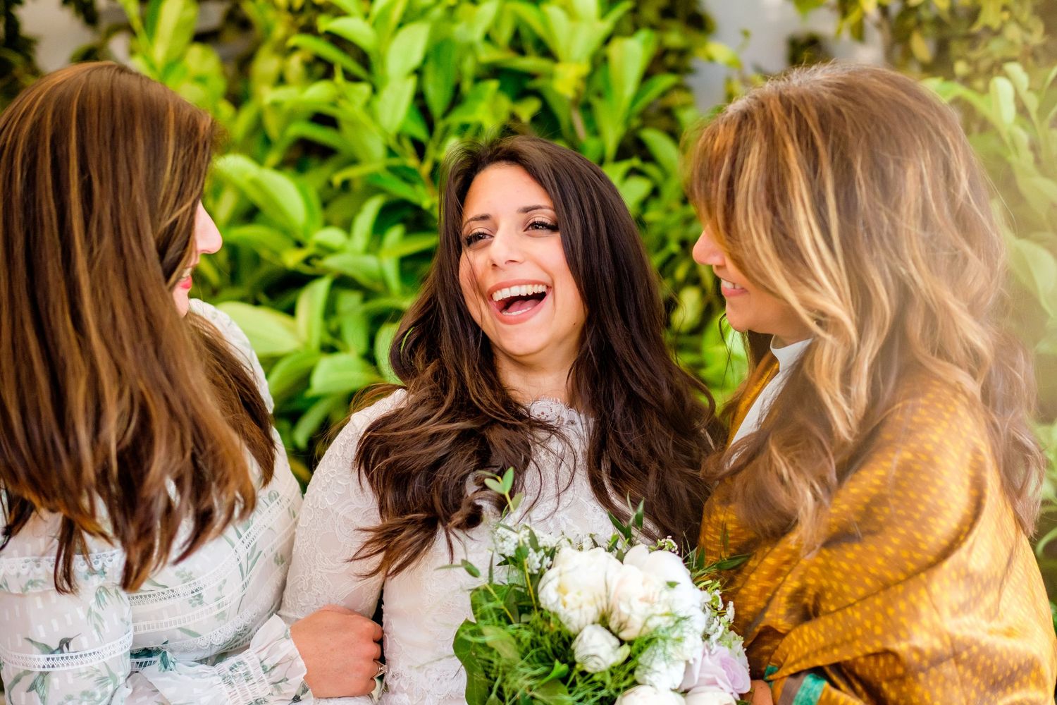 Candid wedding photo series showing joyful moments between people in a garden setting.