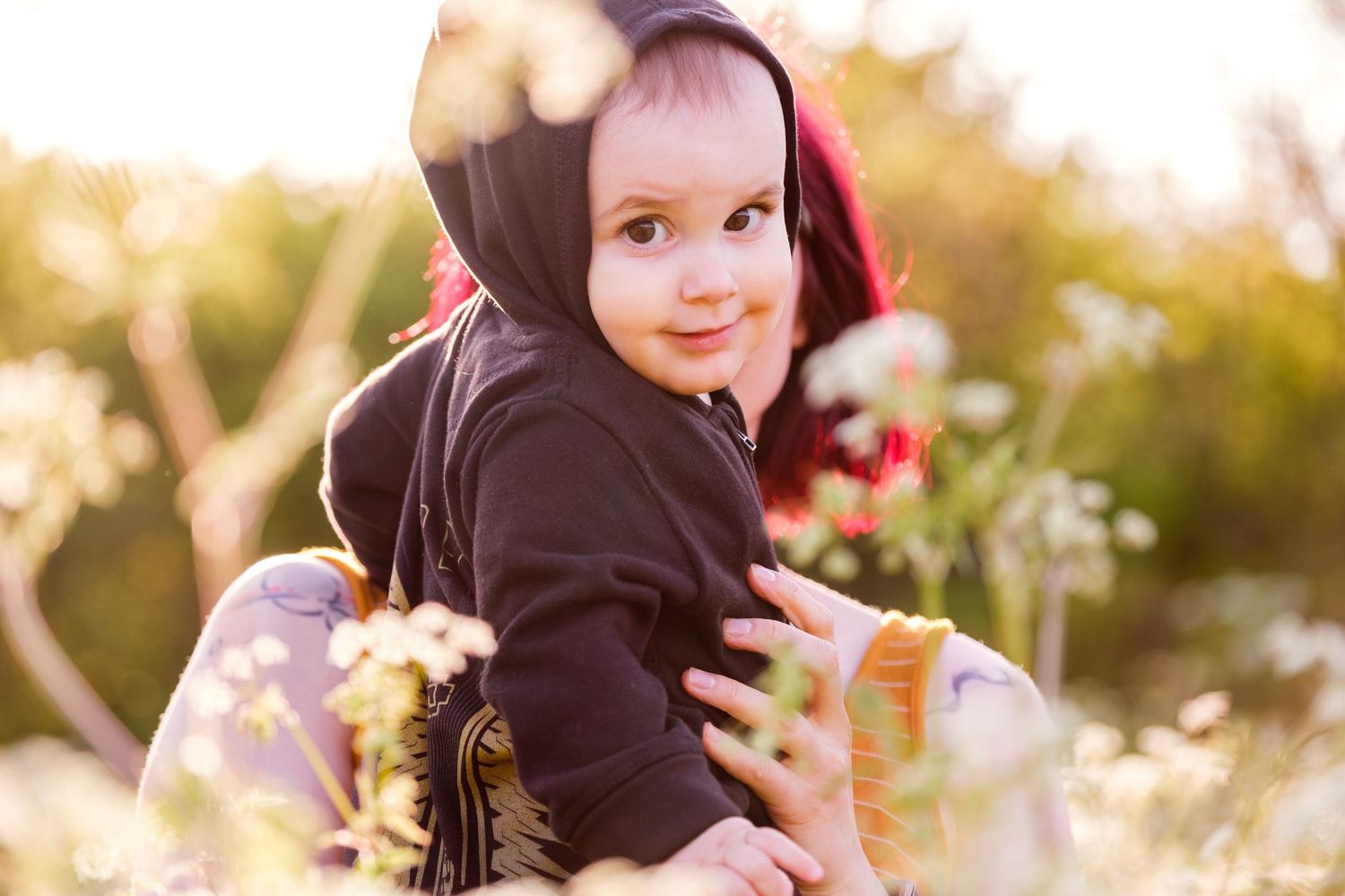 Joyful candid outdoor family moments captured in warm autumn sunlight against natural foliage.