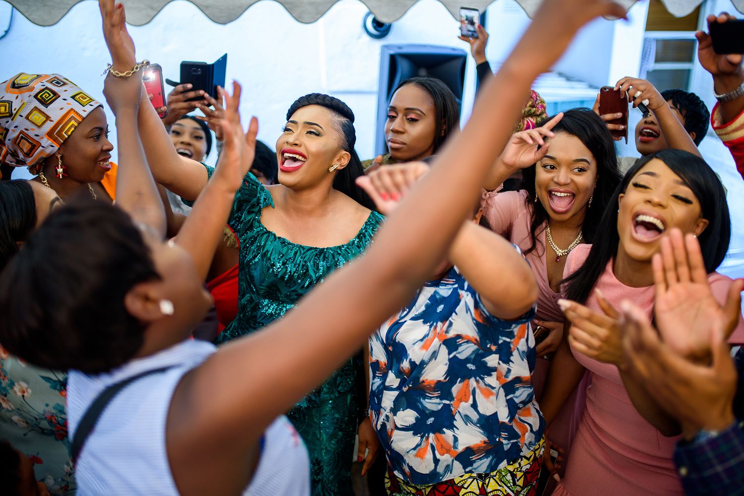 Party attendees enjoying themselves with drinks and laughter at an outdoor celebration.