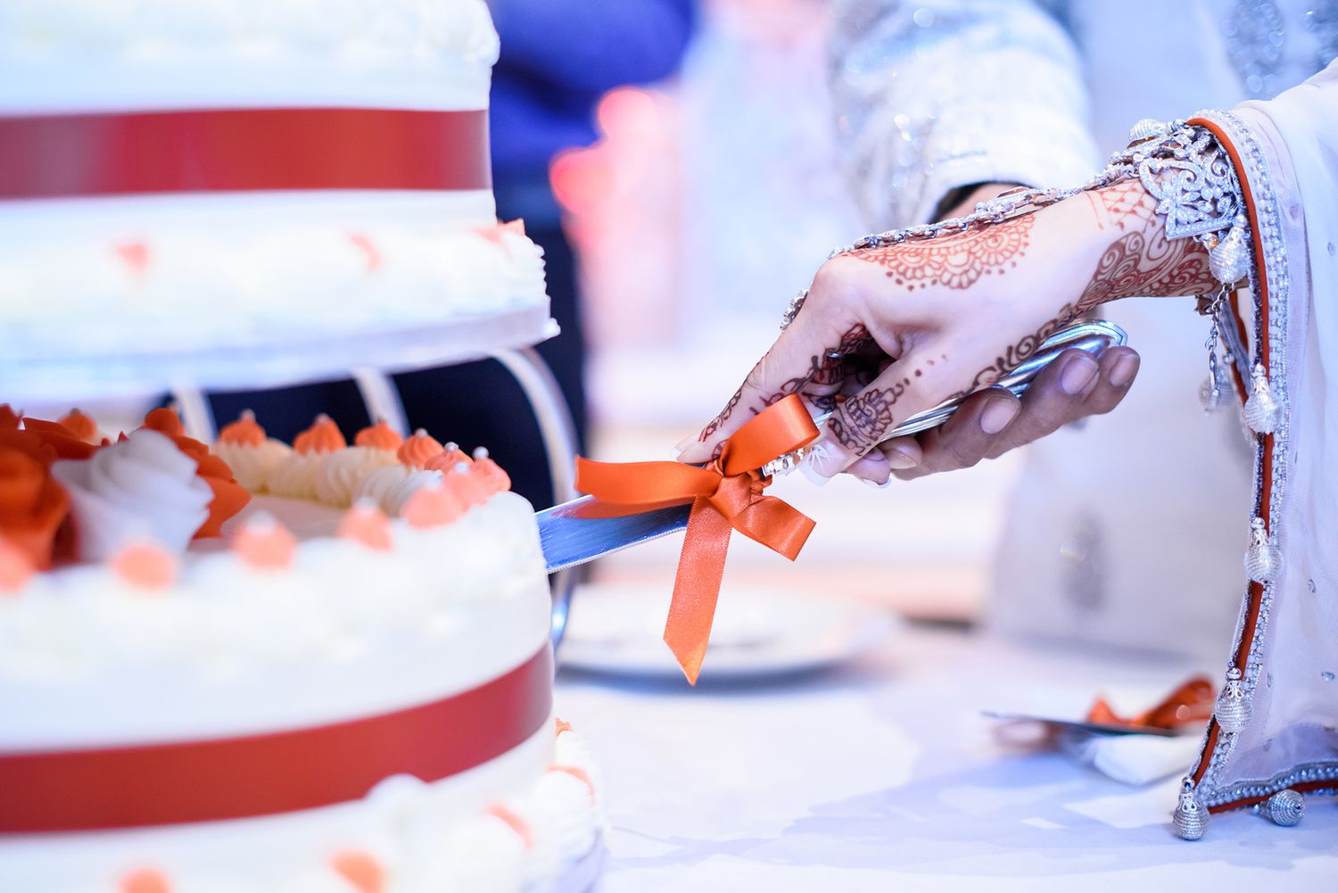Close-up details of traditional wedding decorations and table settings.