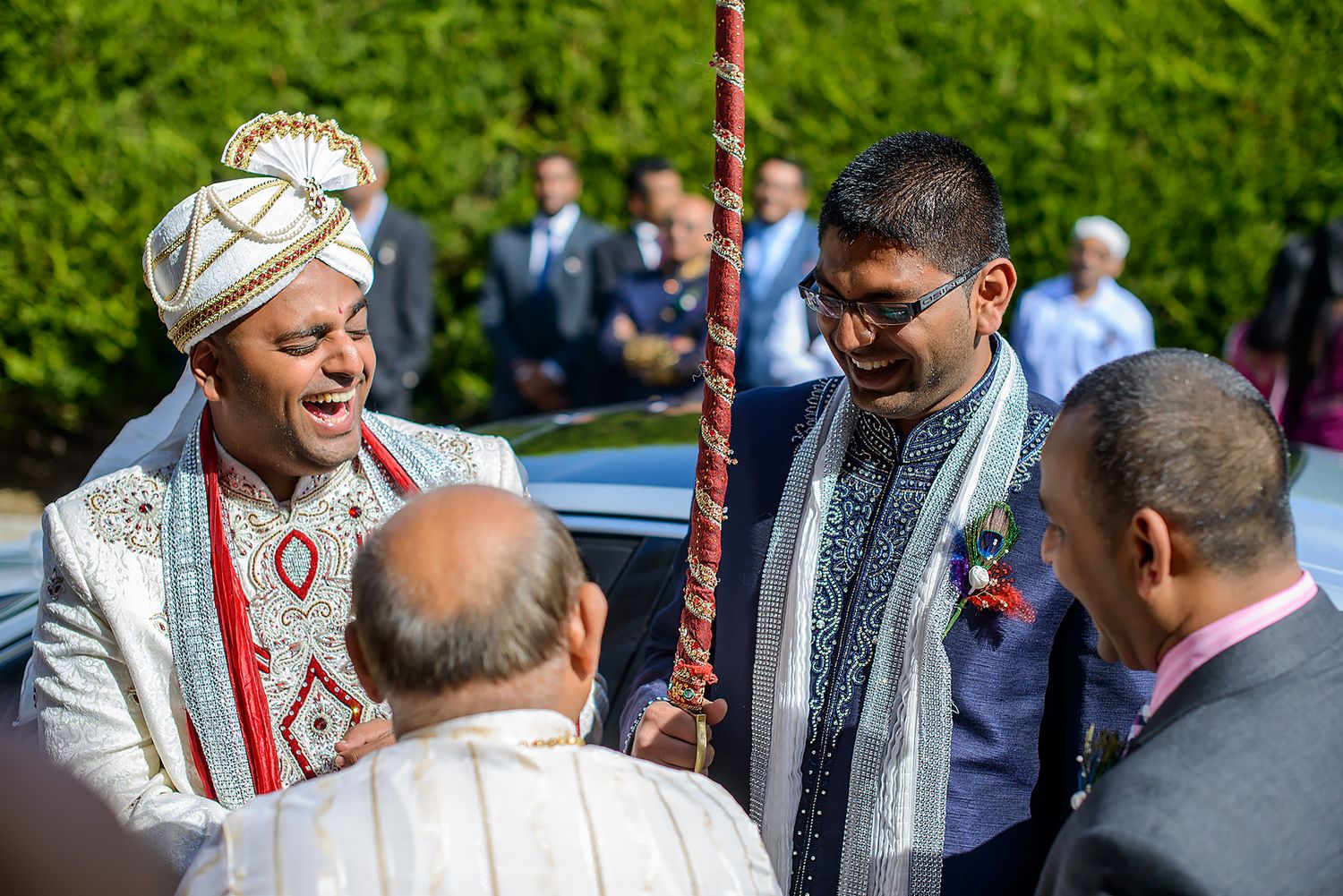Wedding guests and family members gather outdoors for a traditional Indian ceremony.