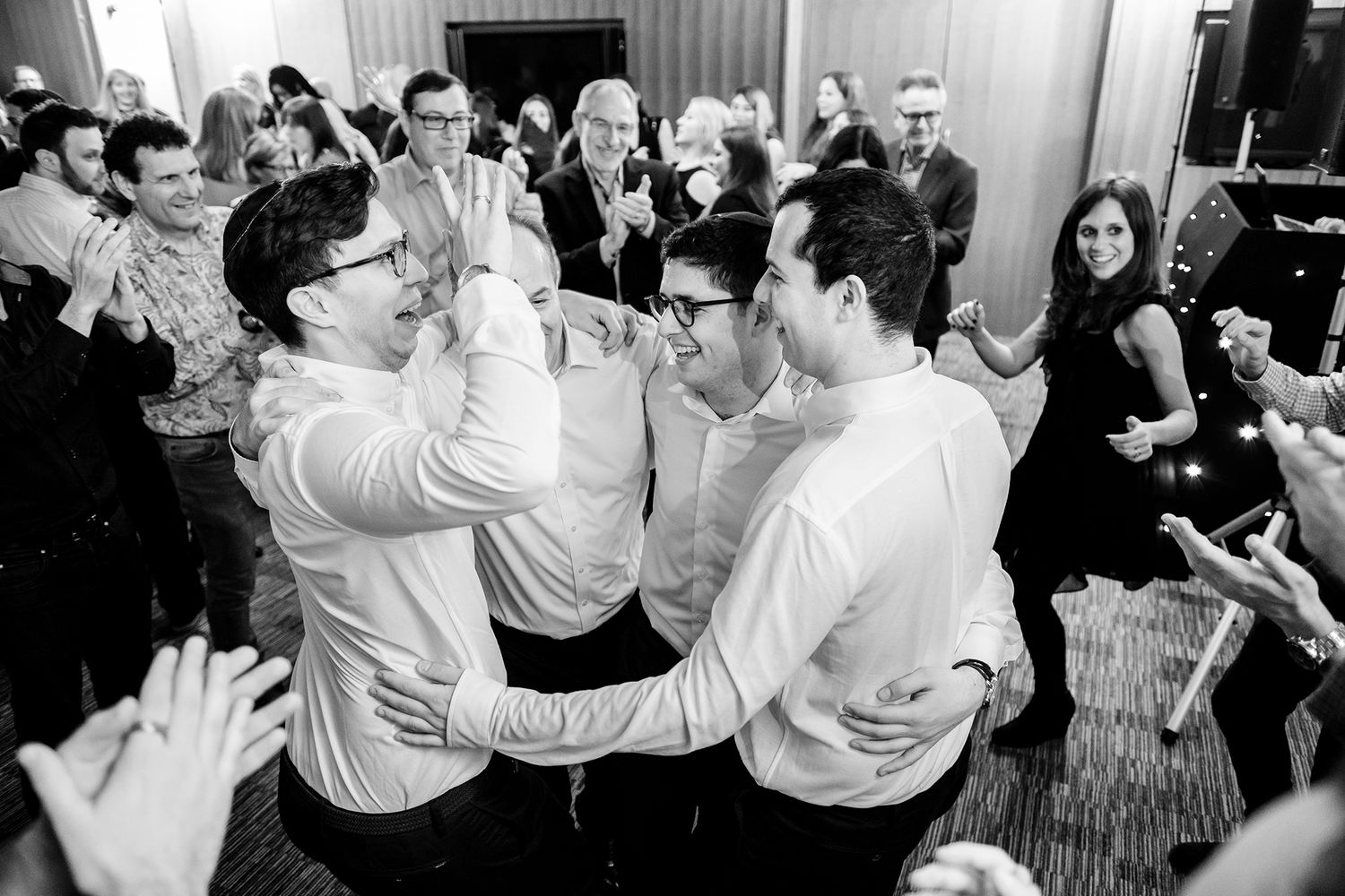 Couples dancing together at an elegant wedding reception party with joyful expressions.