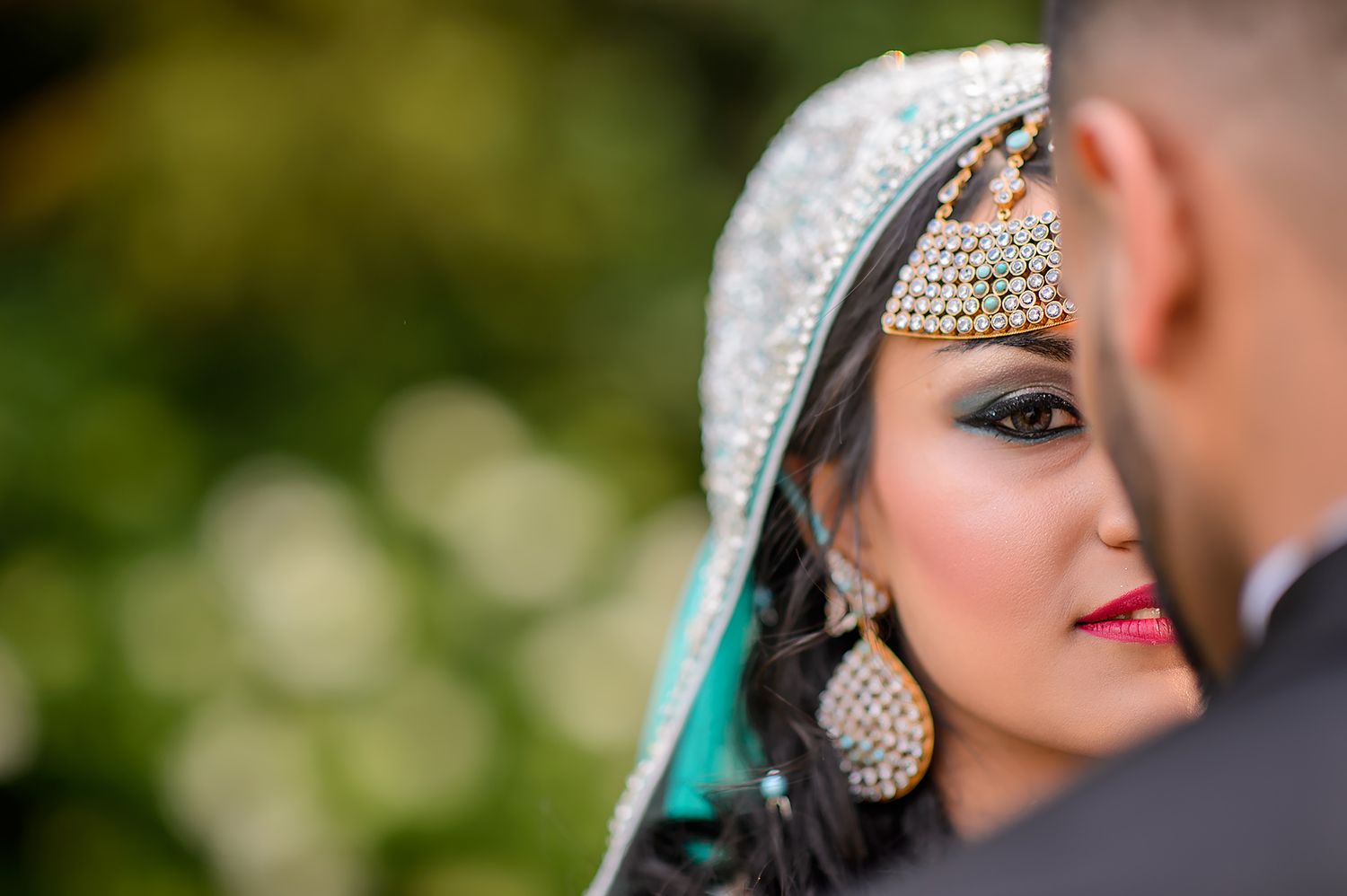 Wedding portrait featuring traditional South Asian bridal jewelry and makeup.