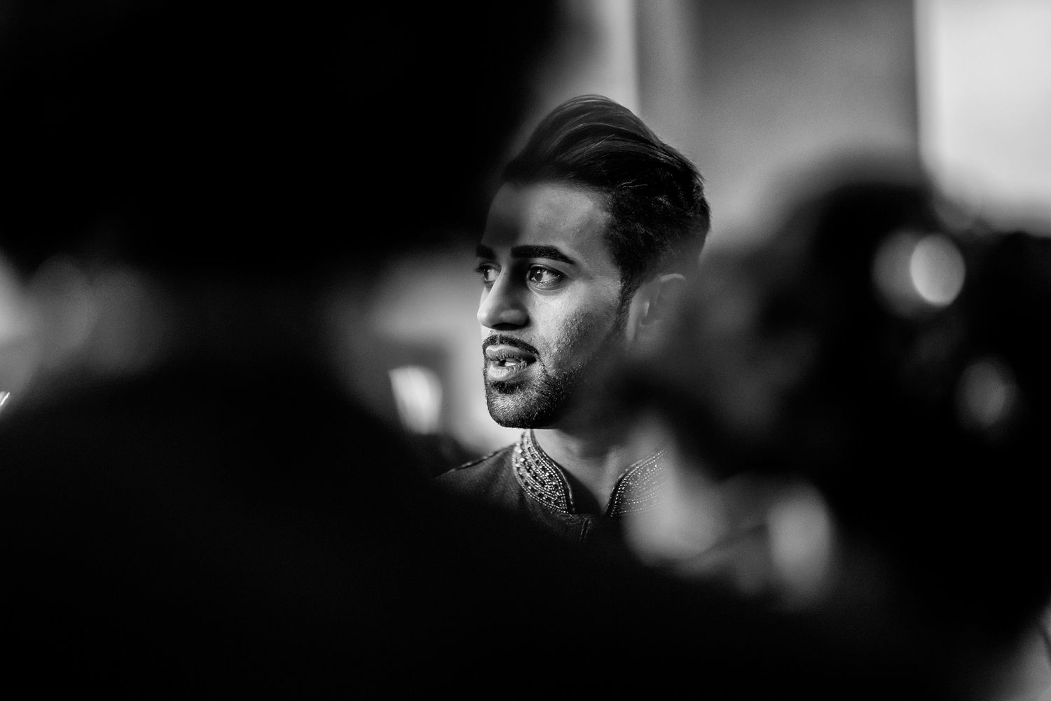 Dramatic black and white portraits with moody lighting at wedding reception.