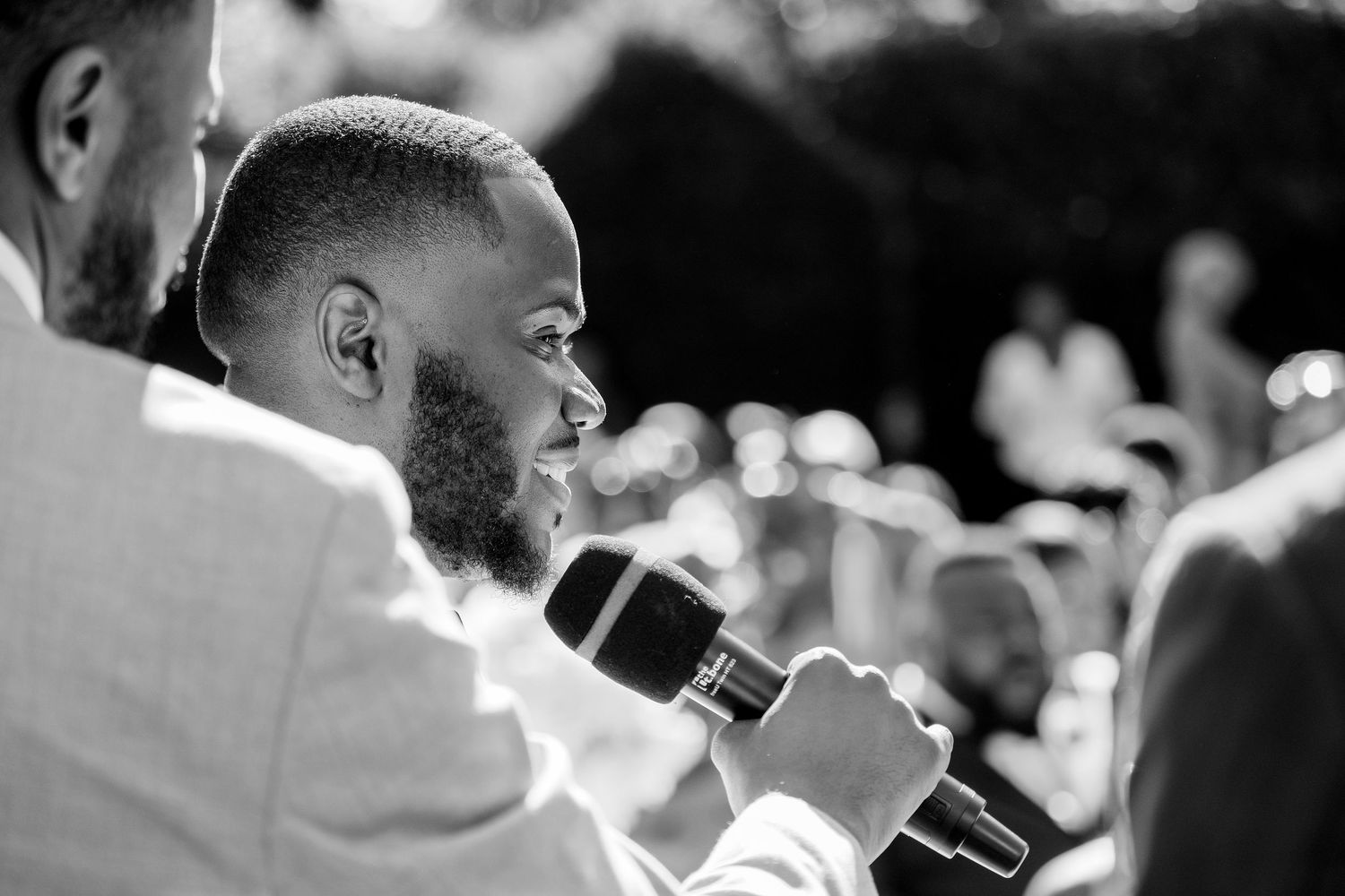 Wedding guests dance and celebrate during a lively outdoor reception.