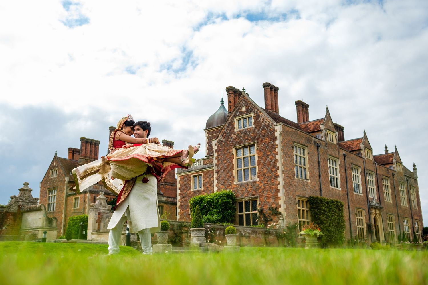 Historic brick mansion with Tudor architecture photographed from multiple angles showing its grand exterior and grounds.