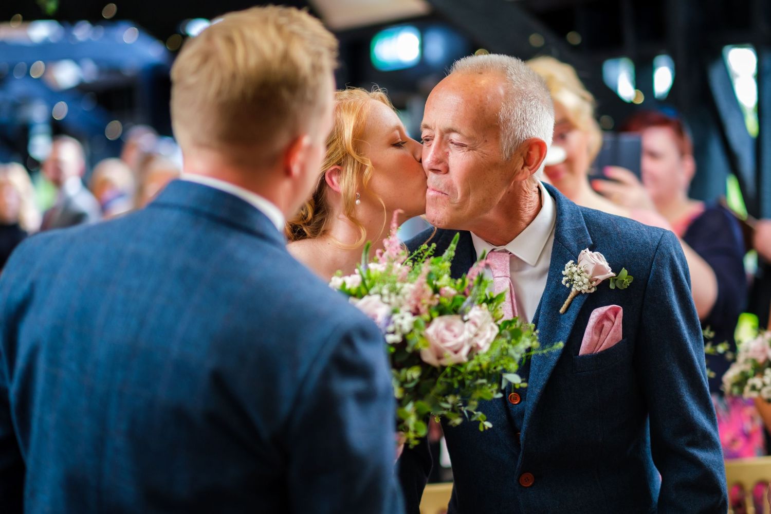 Guests enjoying conversation and laughter during a wedding celebration.
