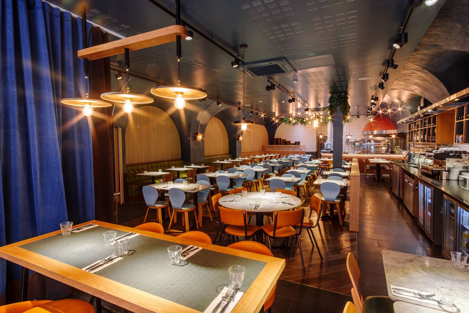 Restaurant interior featuring pool tables and dining areas with ambient lighting.