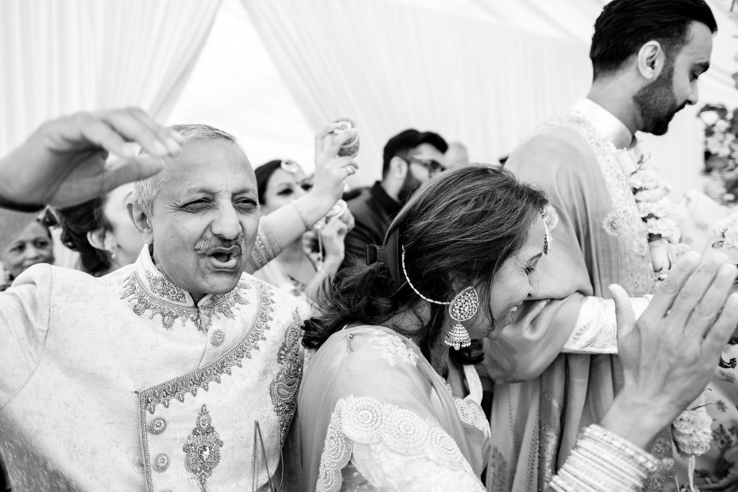 Black and white wedding celebration photo montage showing joyful moments and embraces.