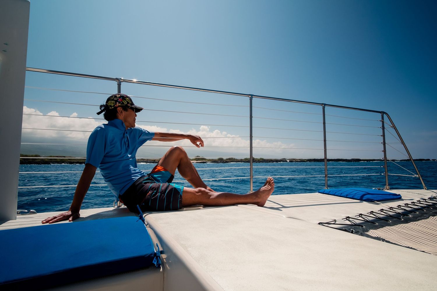 Scenic sailing adventure on a catamaran boat across crystal blue tropical waters on a sunny day.