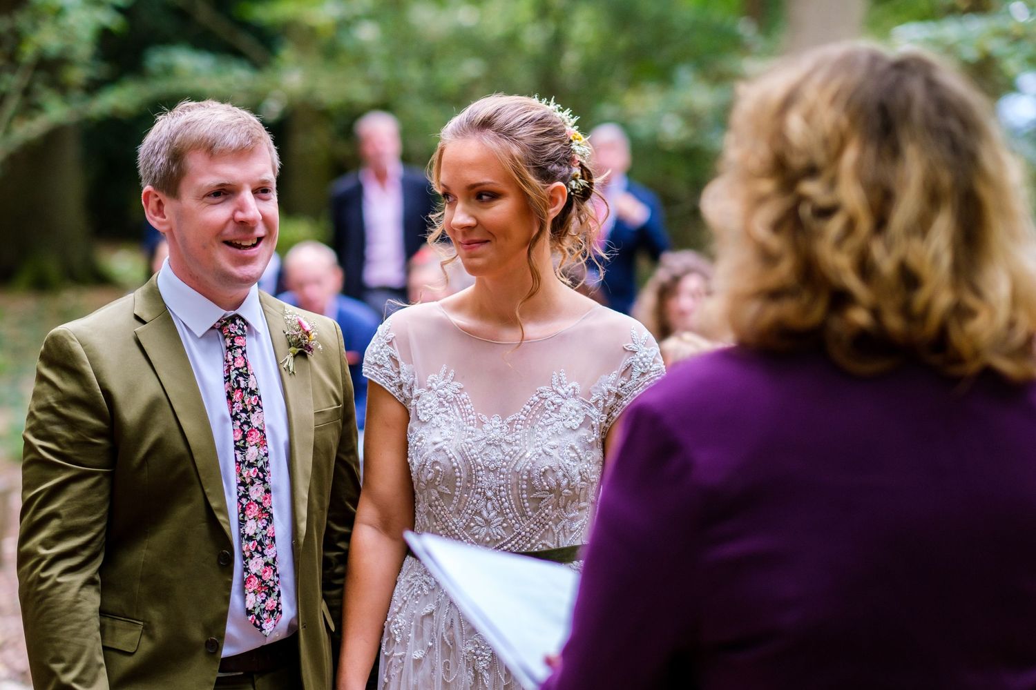 Wedding guests mingling and chatting outdoors during a garden celebration.