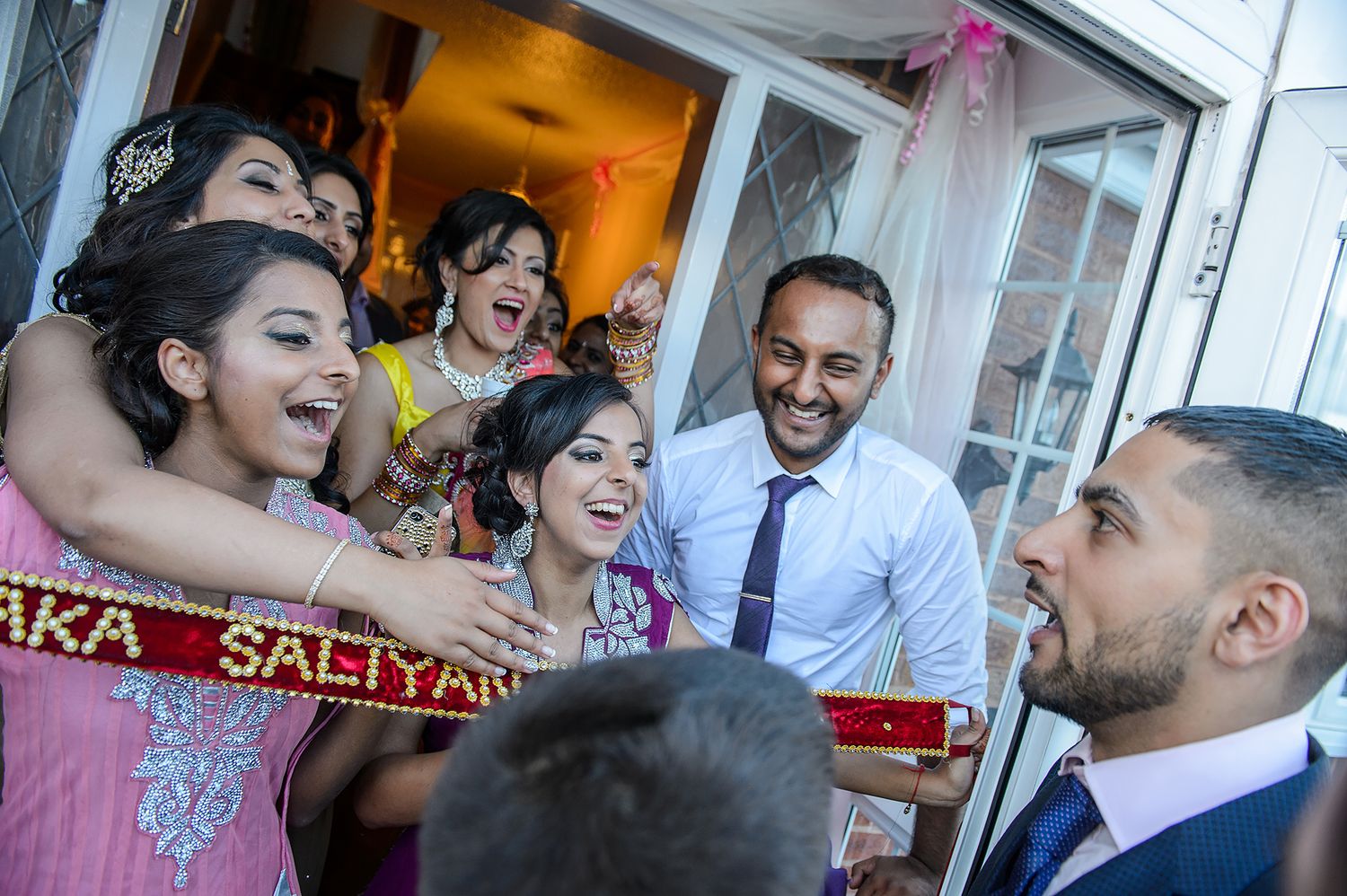 Joyful celebration moment captured at an indoor wedding reception venue.