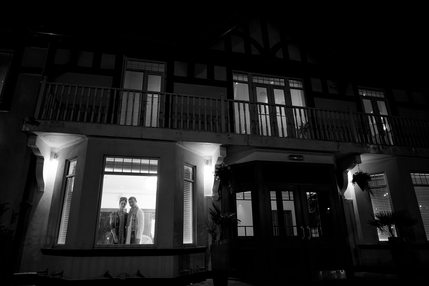 Nighttime exterior view of a venue with warm lighting and architectural details.