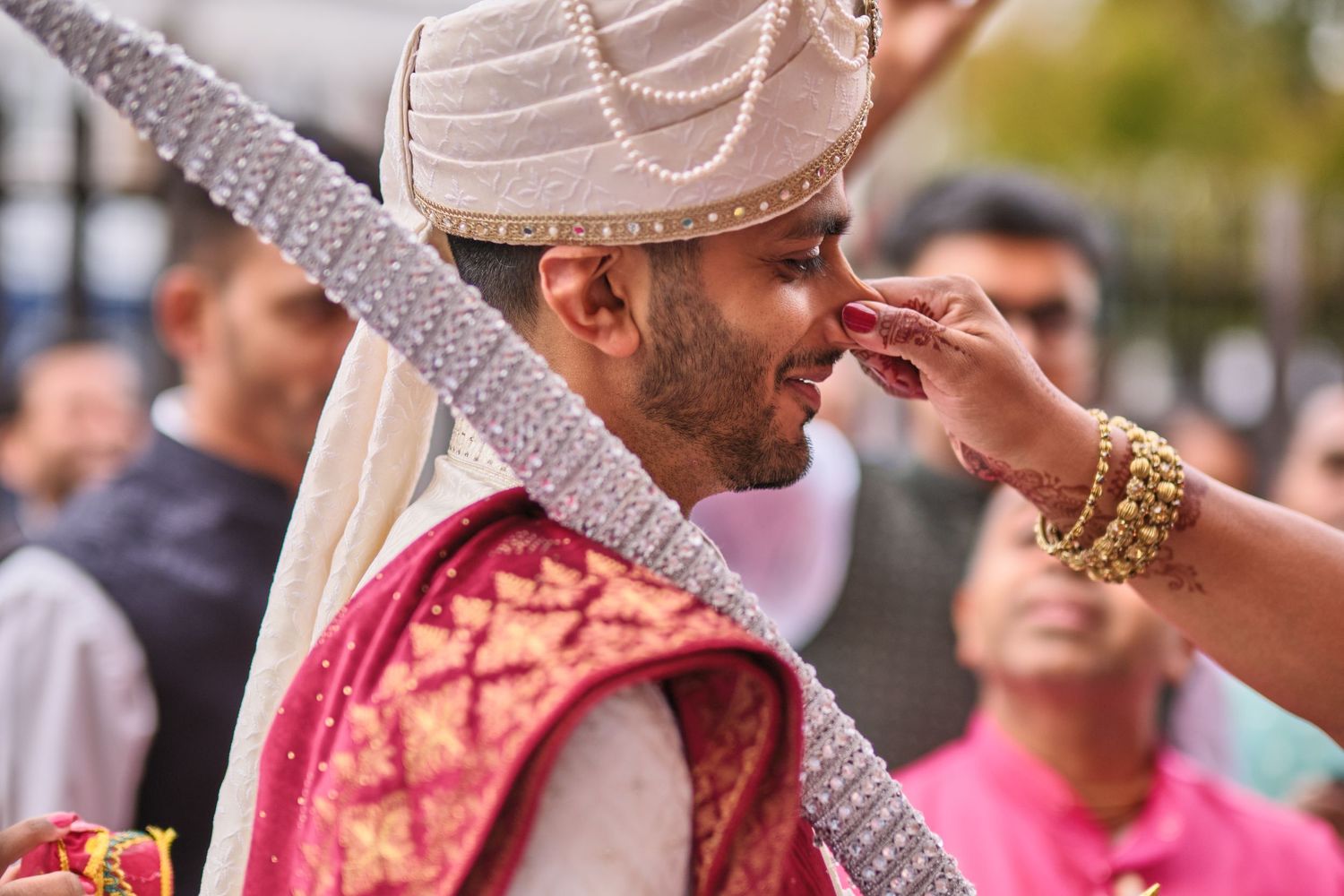 Traditional Indian wedding ceremony with the bride and groom performing rituals under a decorated mandap.