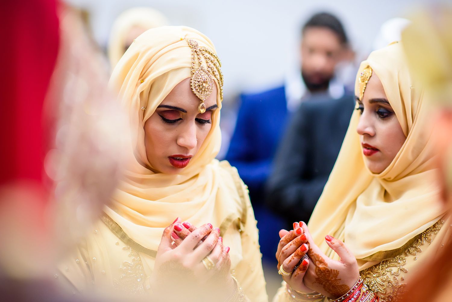 Wedding guests in elegant traditional dress during celebration.
