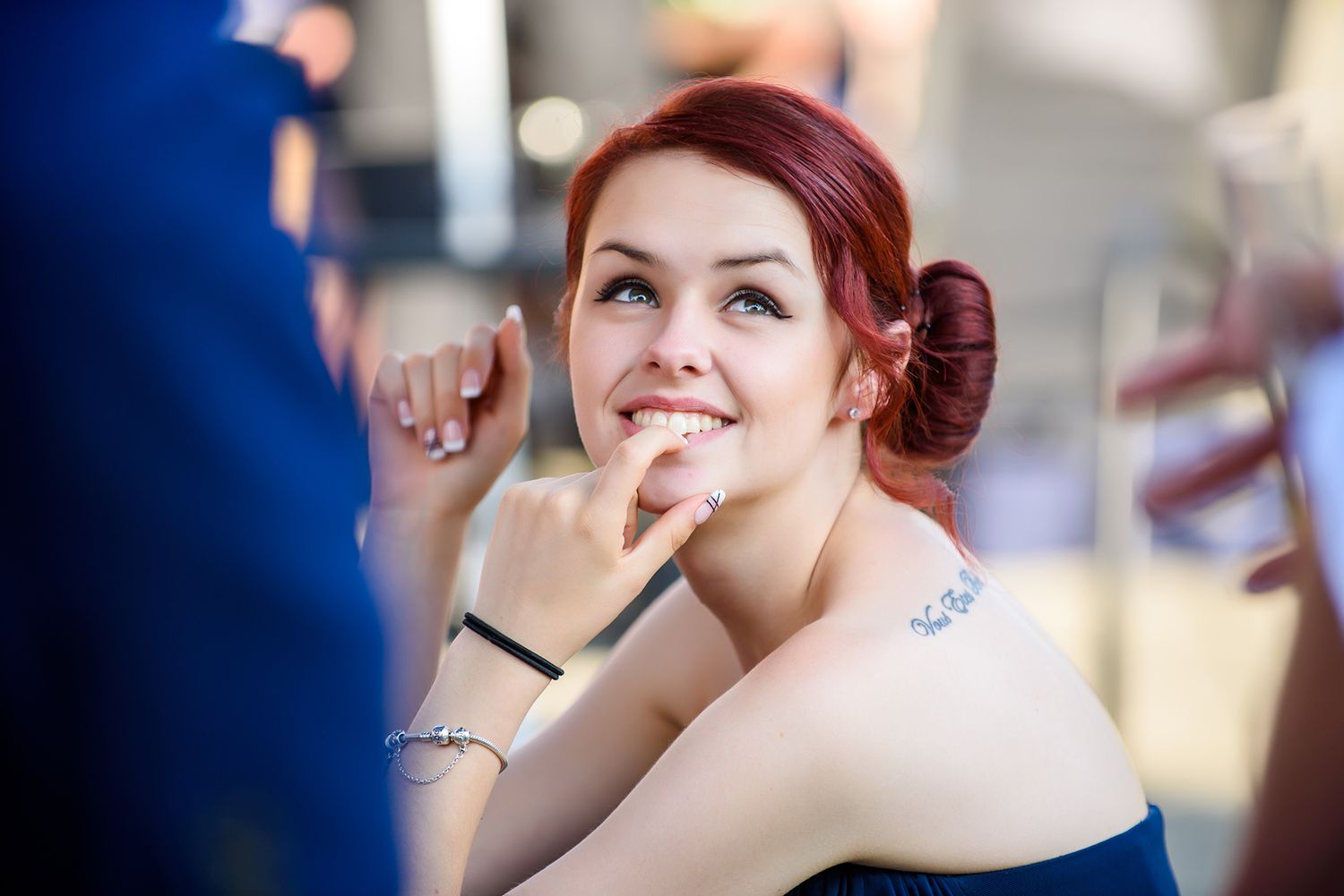 Bride getting her makeup professionally applied during wedding preparations in natural lighting.