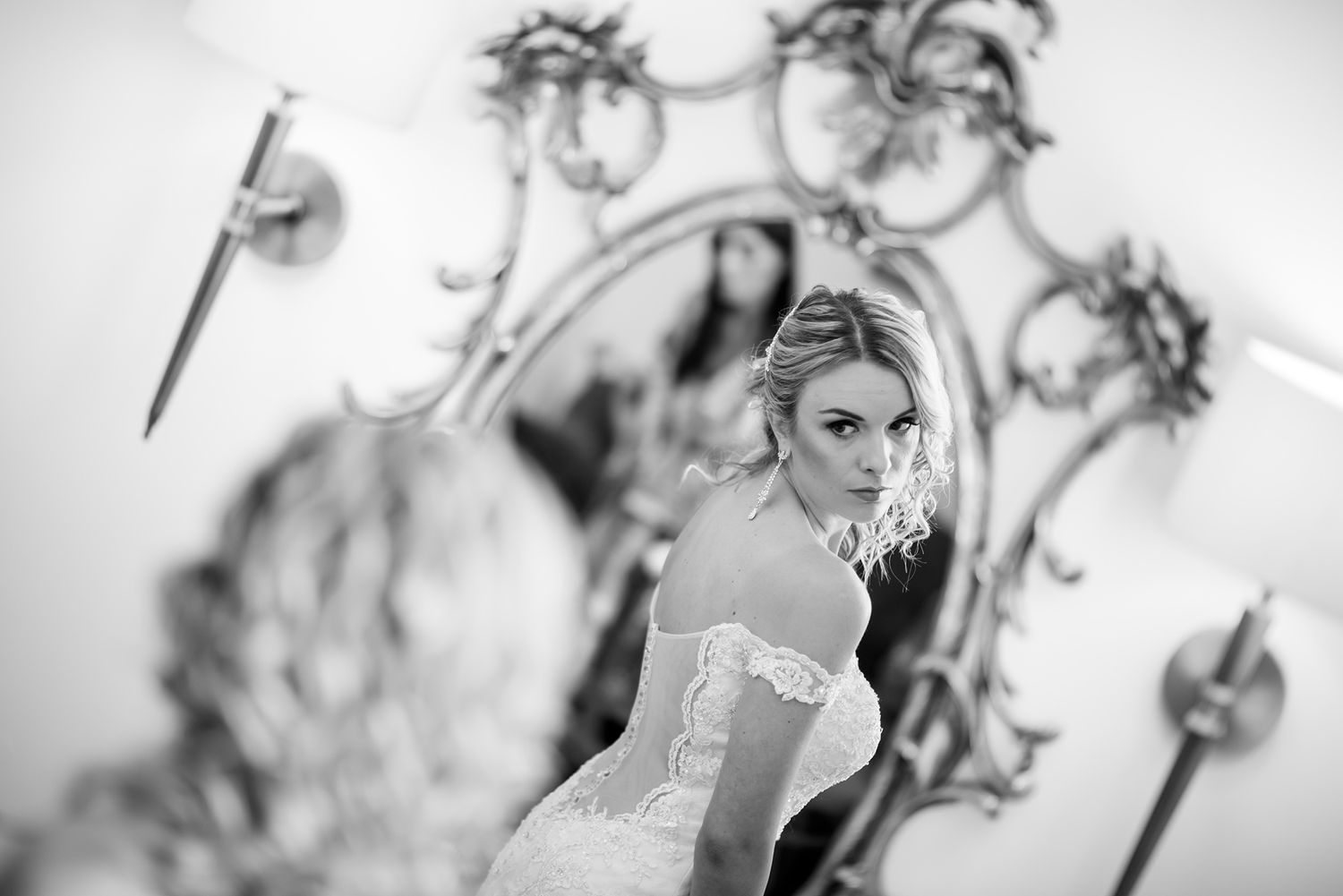 Artistic black and white shots of wedding preparations in vintage-style mirrors.