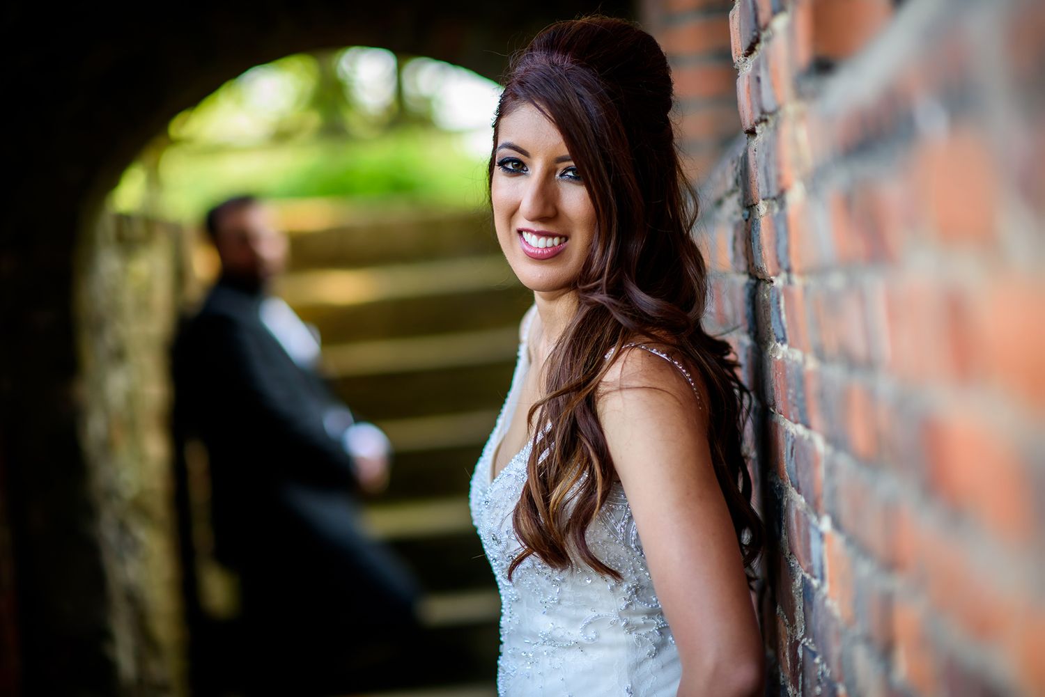 Beautiful bridal portraits taken against exposed brick walls with natural lighting.