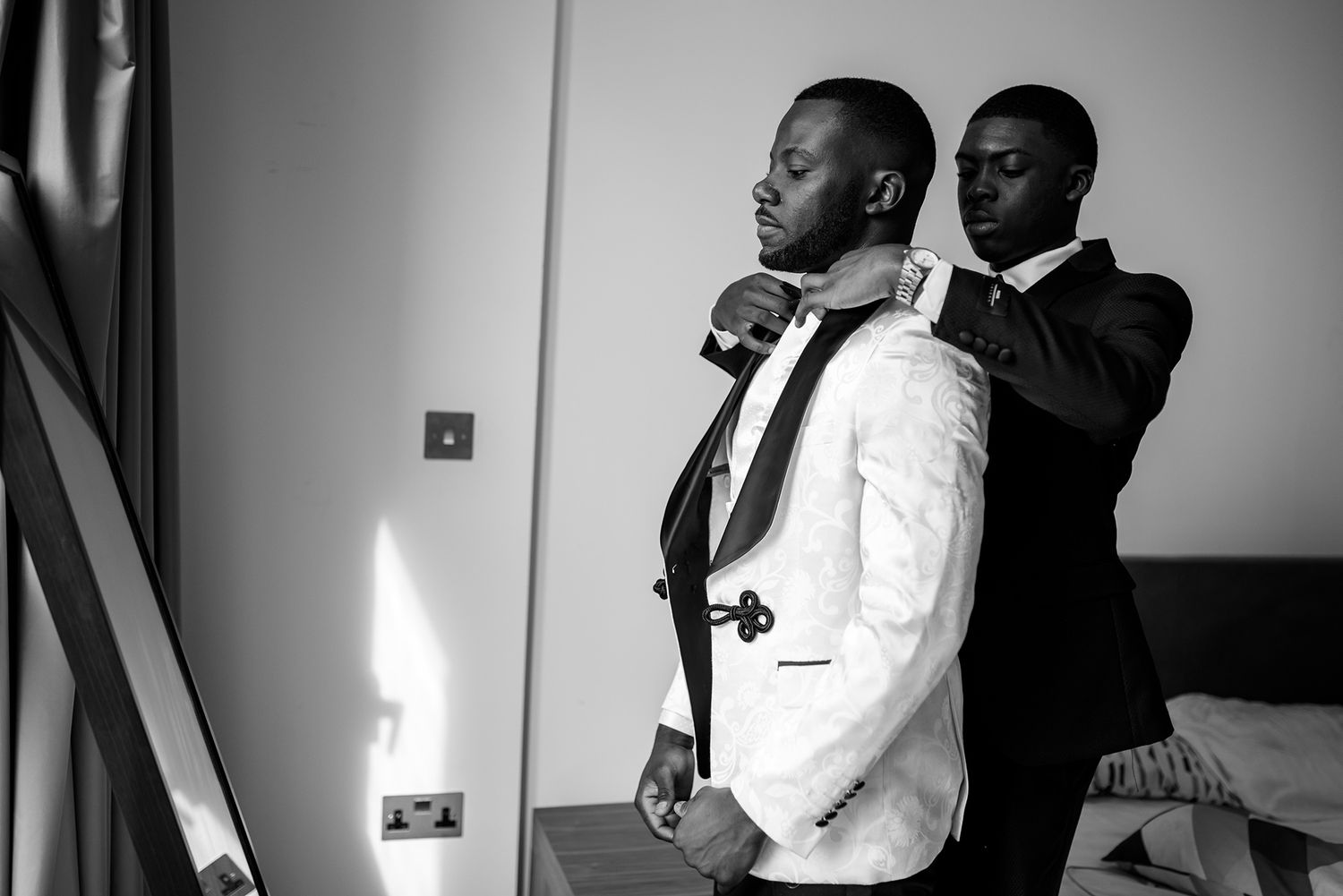 Elegant black and white portraits showing wedding preparations in formal attire.