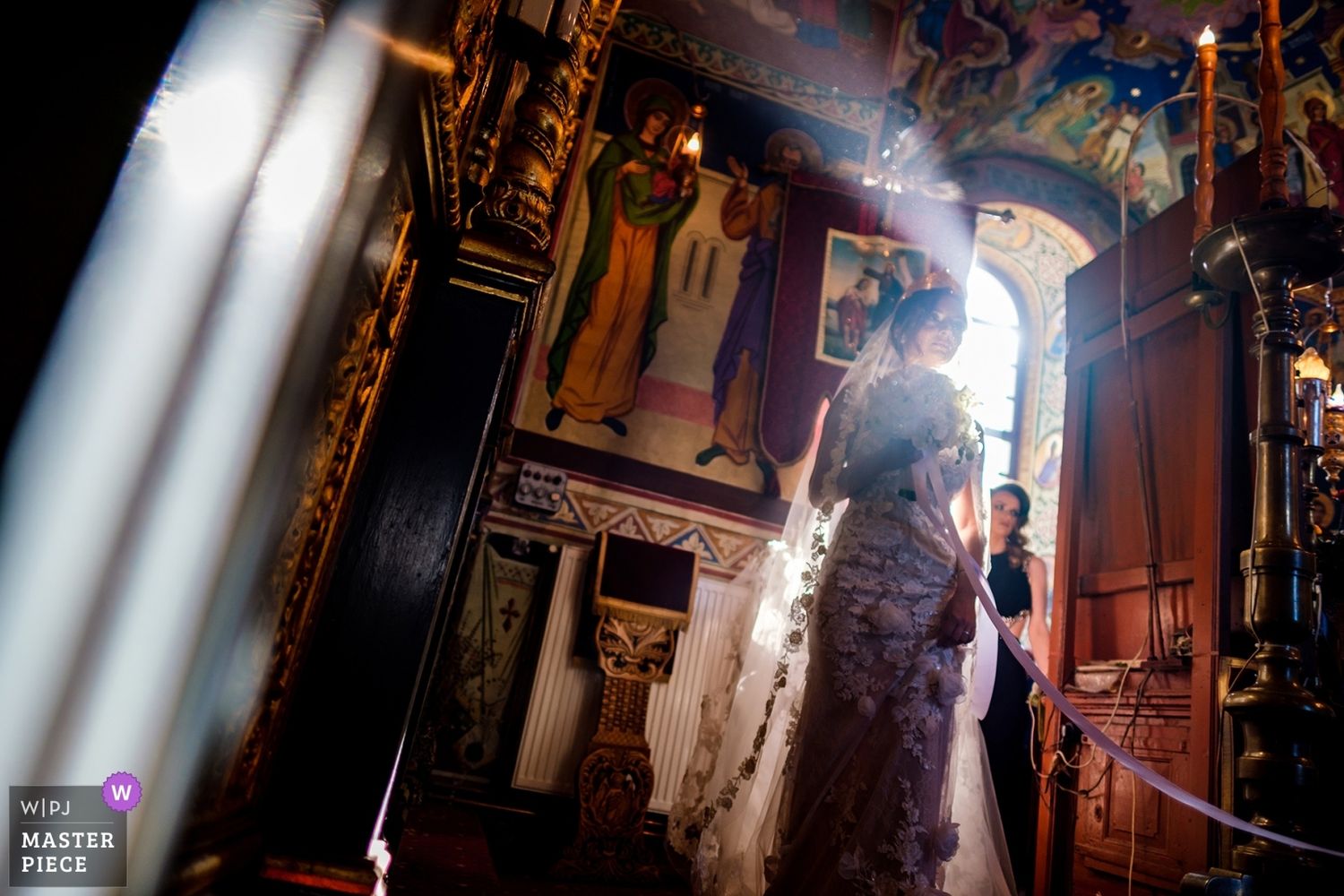 Dramatic architectural shot of wedding venue with sunlight streaming through windows.