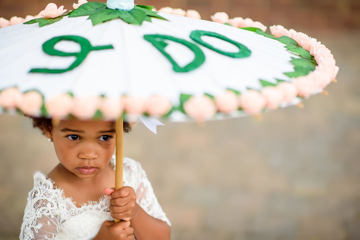 Wedding cake adorned with delicate green leaf decorations and white frosting.