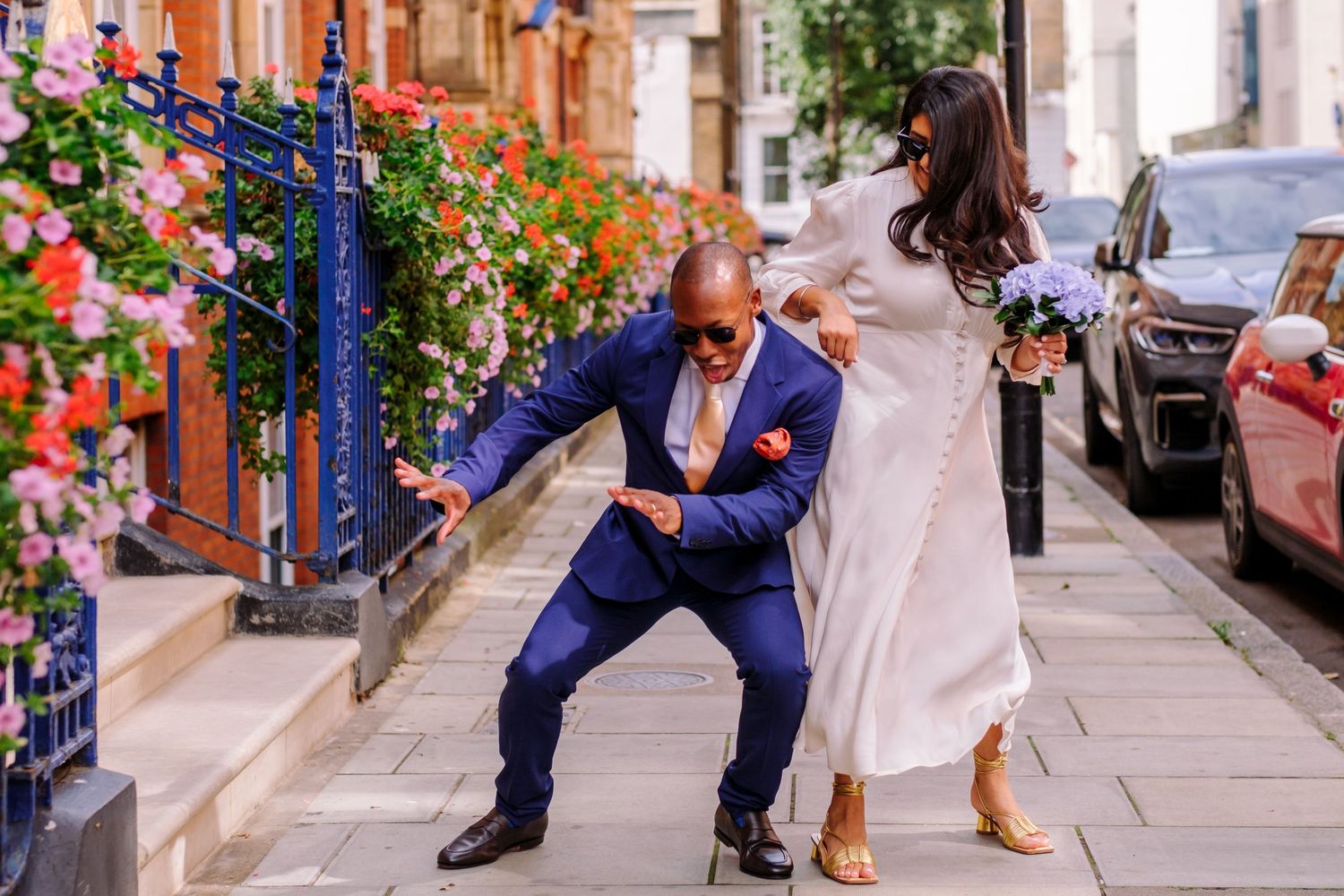 Couple shares romantic moments on a colorful city street during their wedding photoshoot.