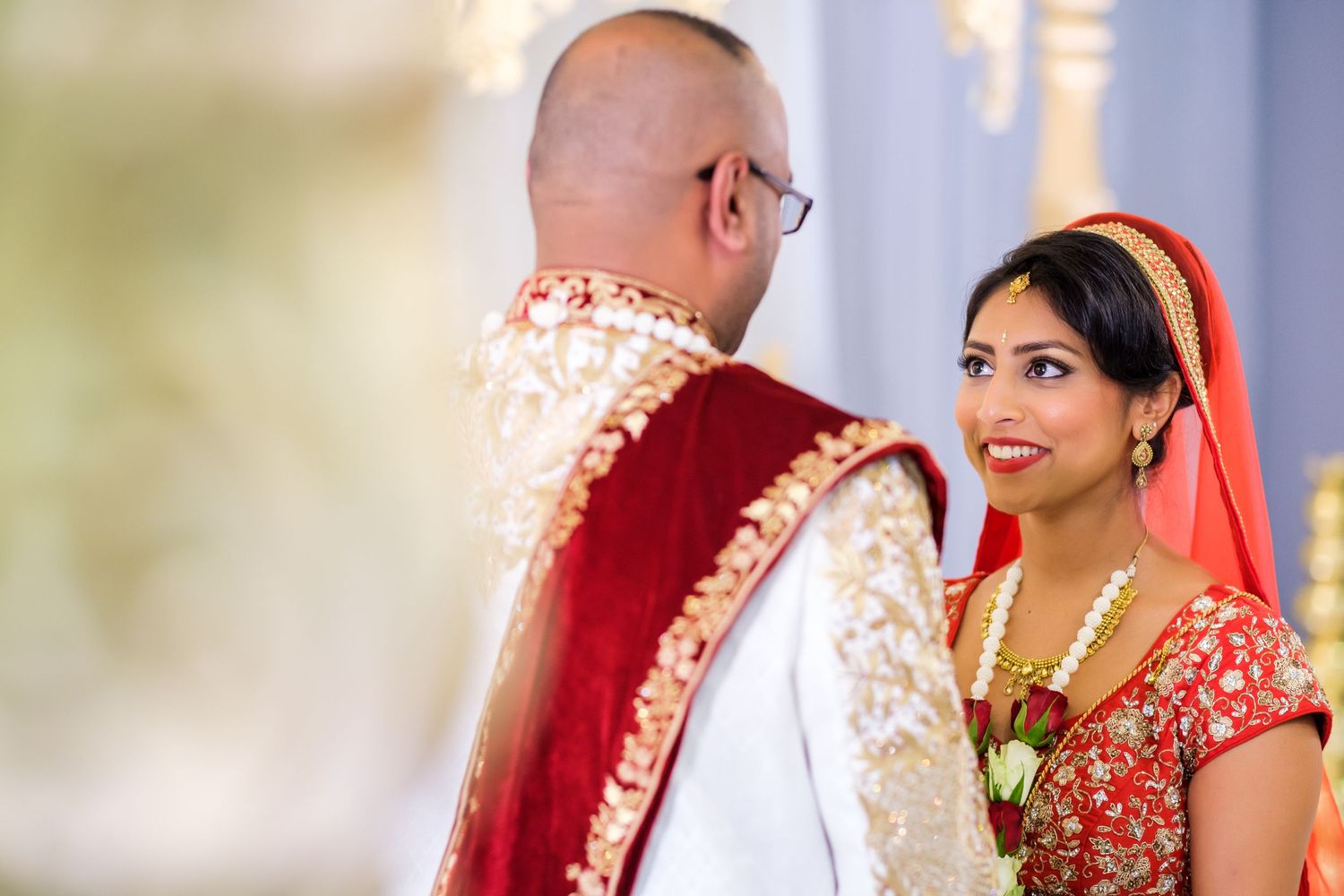 Close-up shot of a couple in traditional Indian wedding attire during their ceremony.