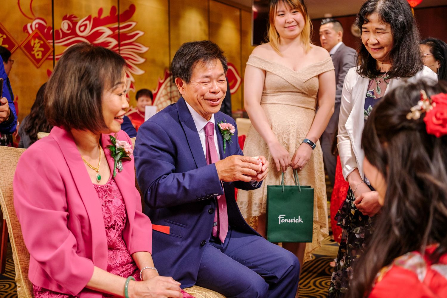 Guests enjoying a lively celebration at a Chinese restaurant with red lanterns and festive decorations.