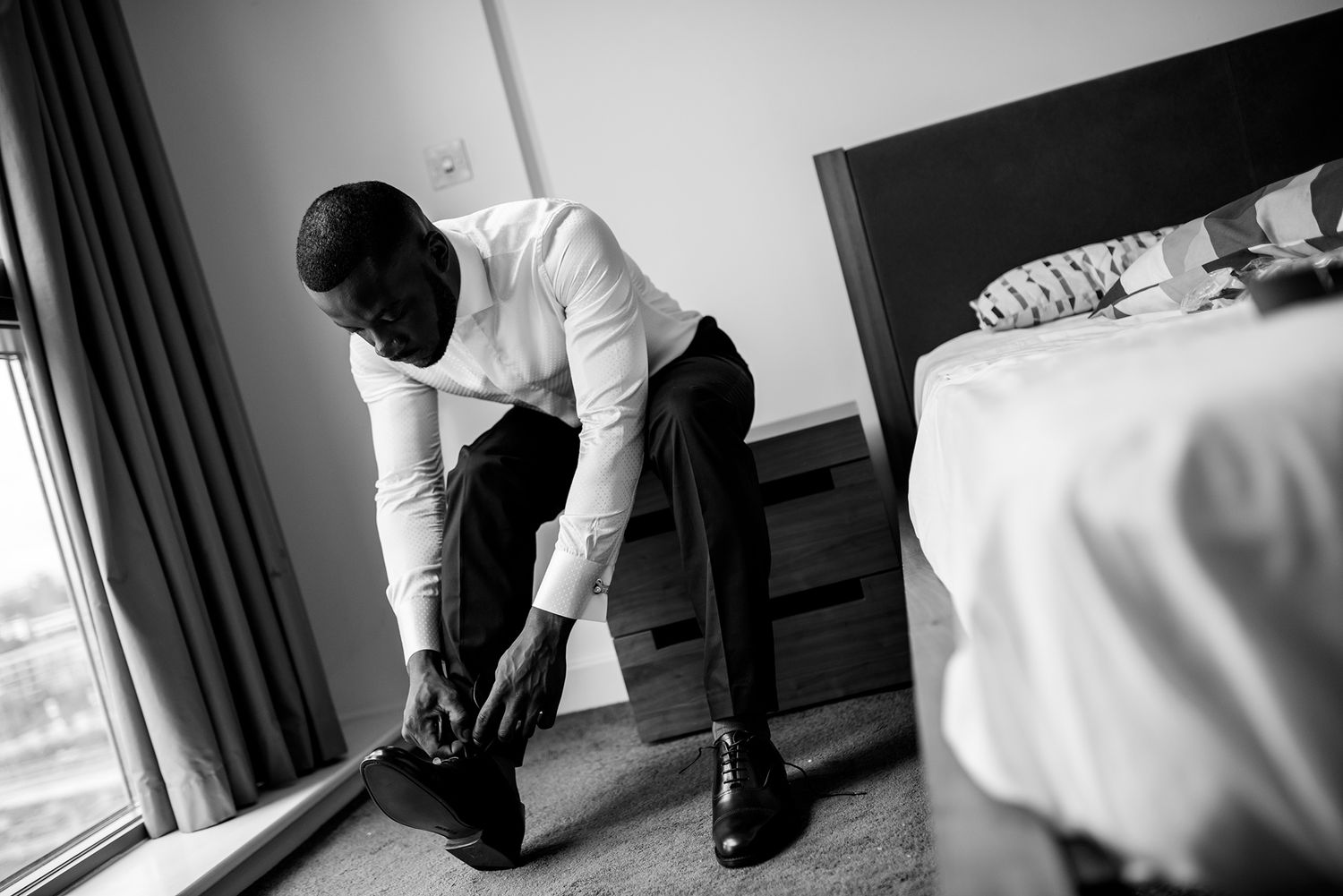 Black and white getting ready moments captured in a hotel room before the ceremony.