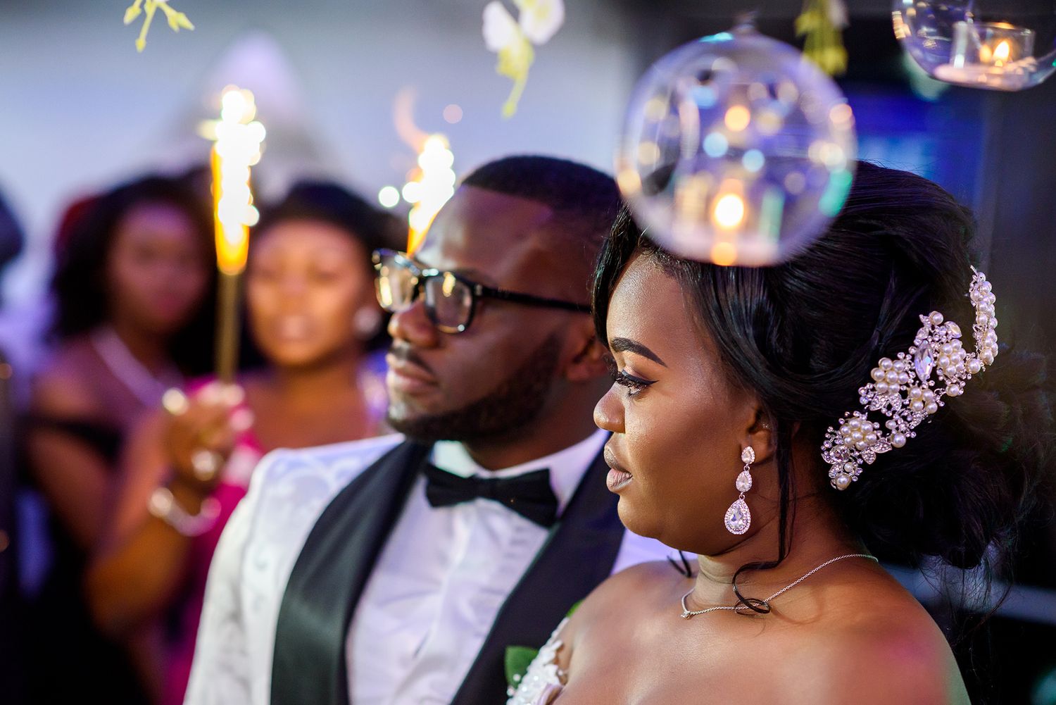 Romantic dance scene with elegant lighting and formal attire at a wedding reception.