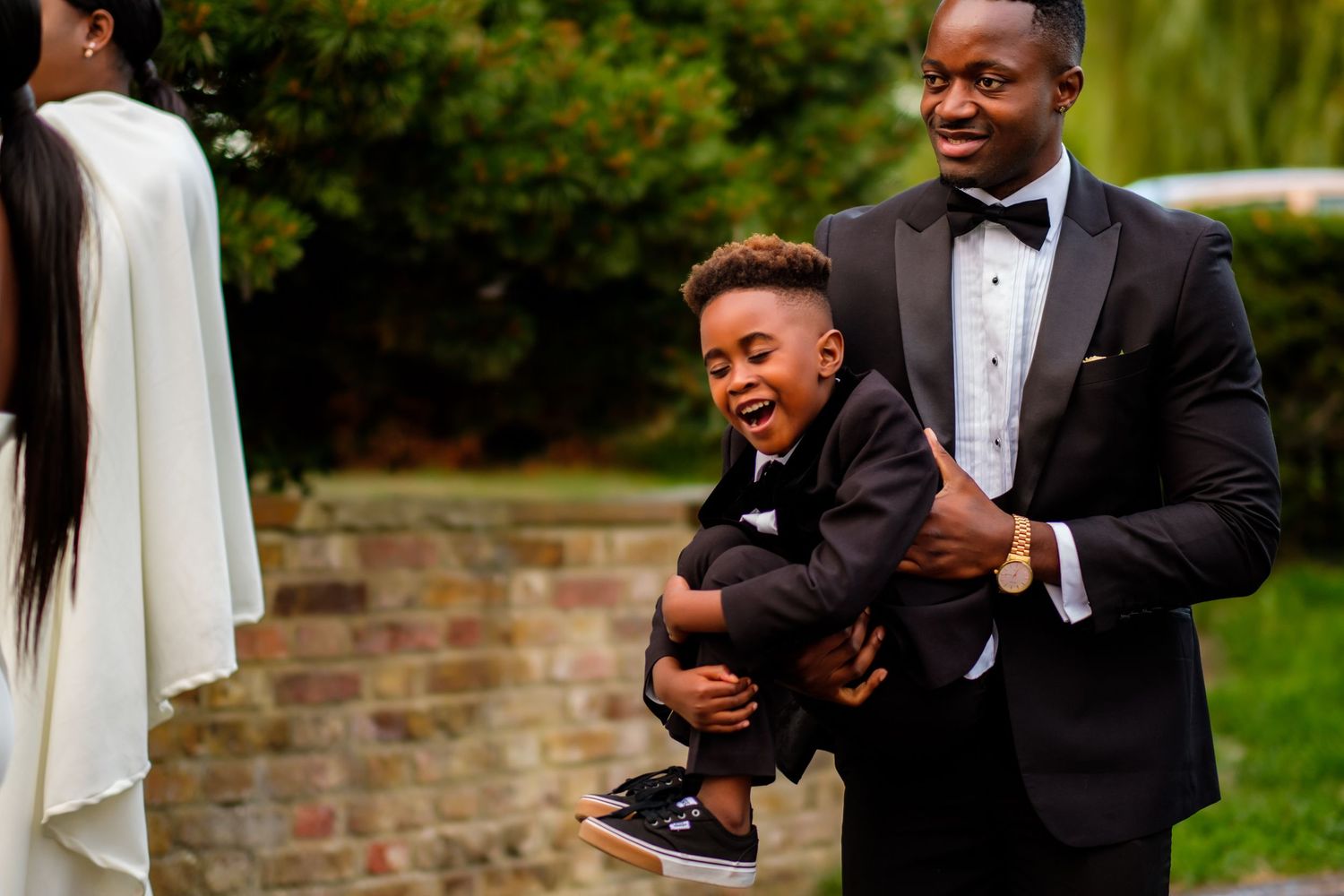 Wedding party sharing candid laughs and joyful moments in formal attire.