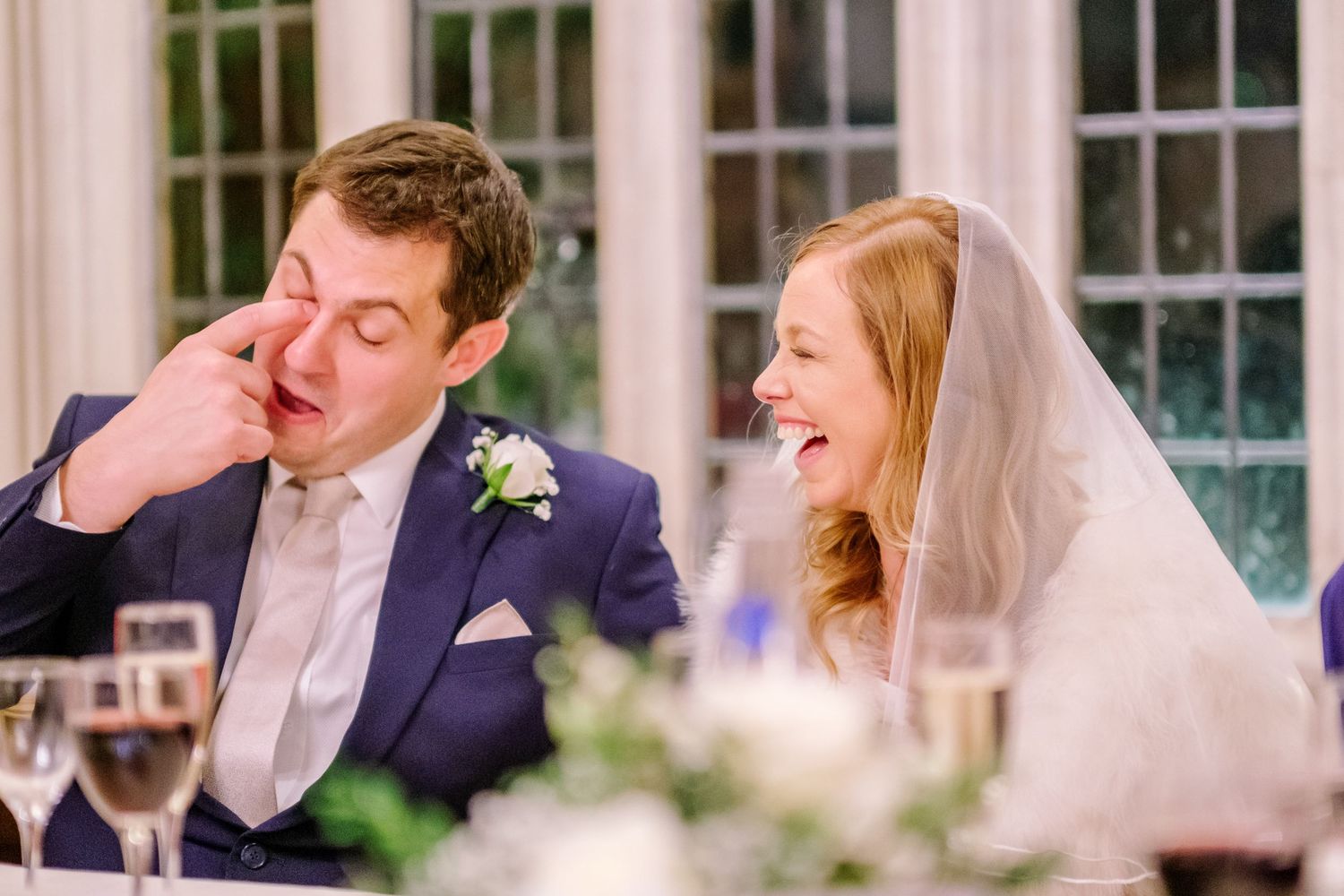 Joyful wedding celebration moment captured through window panes.