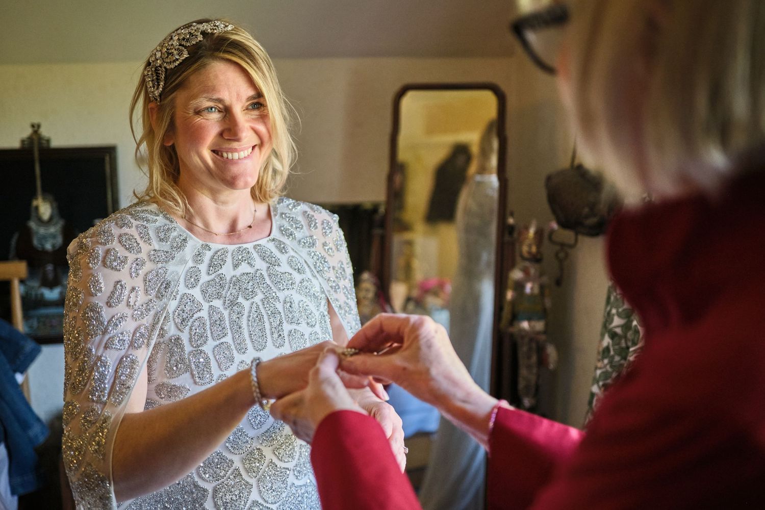 A couple sharing a joyful moment in formal attire with delicate lace details.