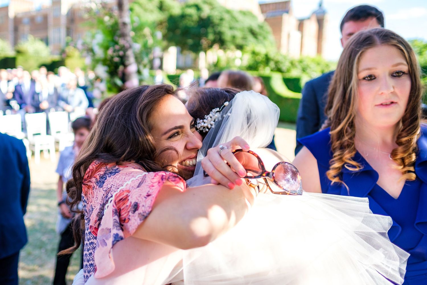Wedding guests enjoy an outdoor celebration on a sunny afternoon.
