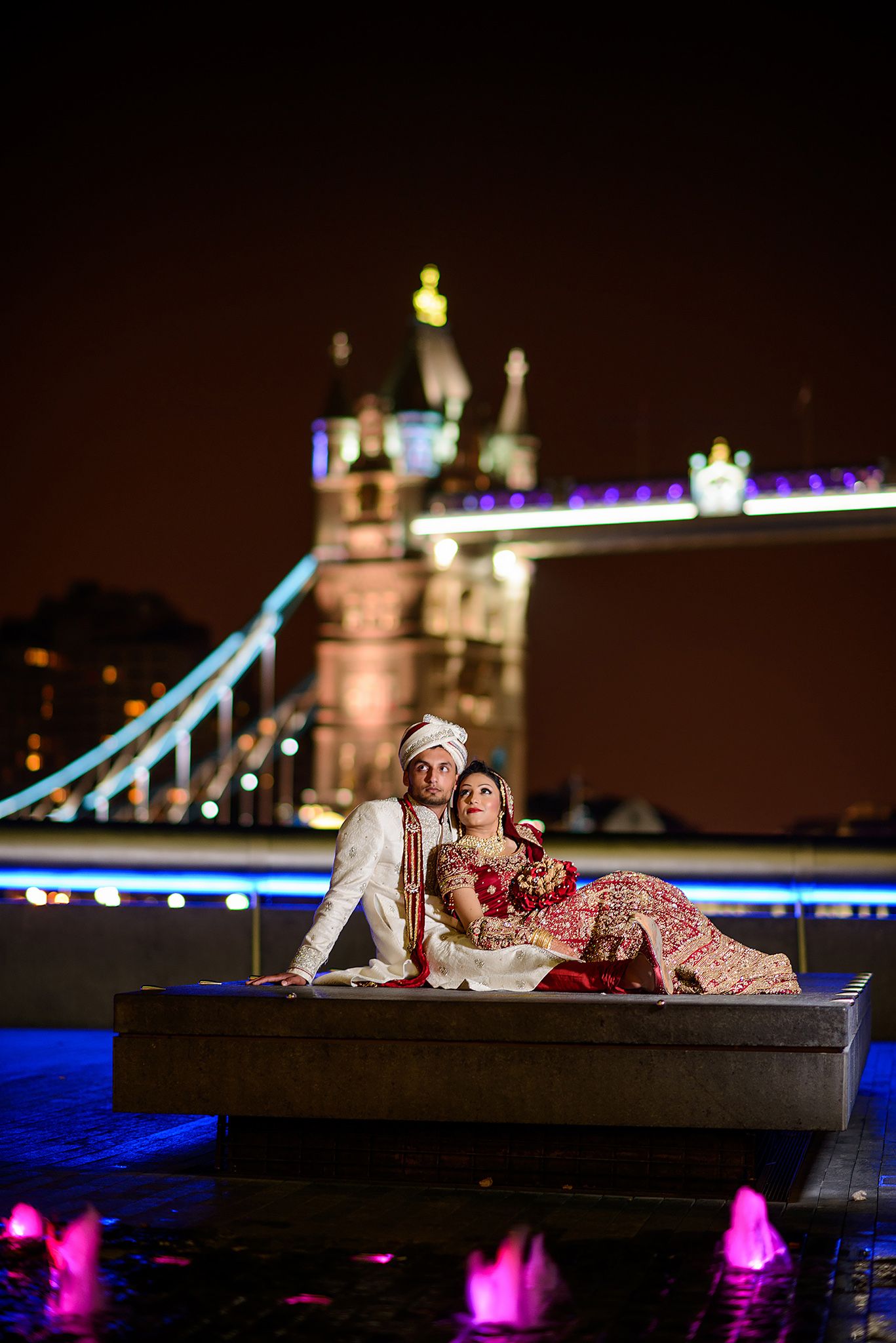 Stunning nighttime photo with colorful lights and illuminated architecture in the background.
