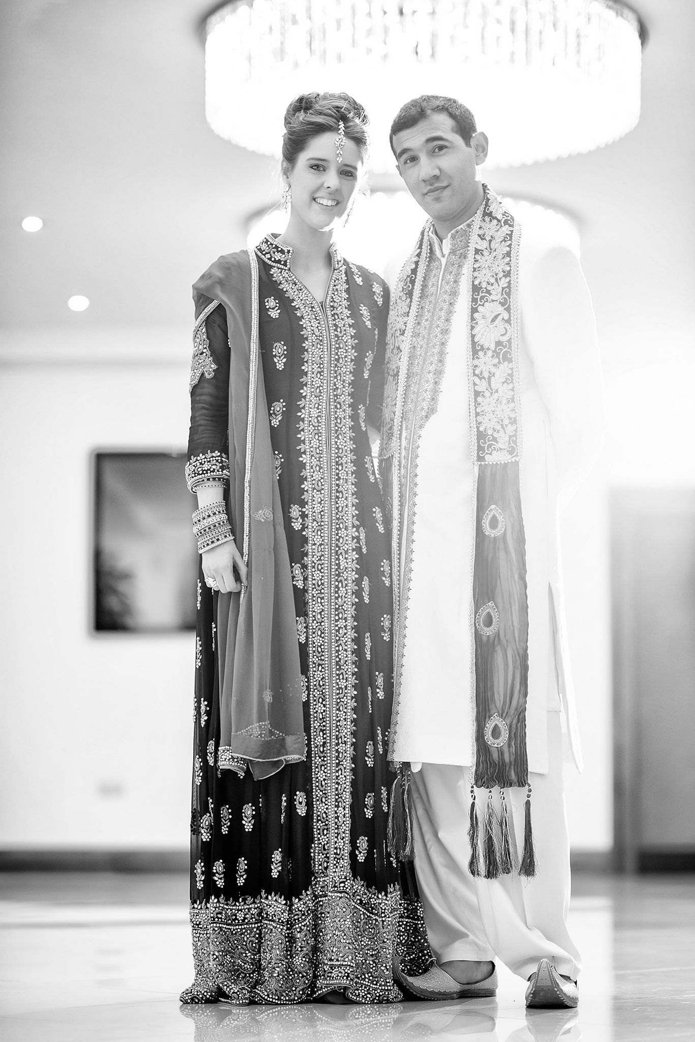Black and white portraits showcase elegant traditional wedding outfits with detailed embroidery.