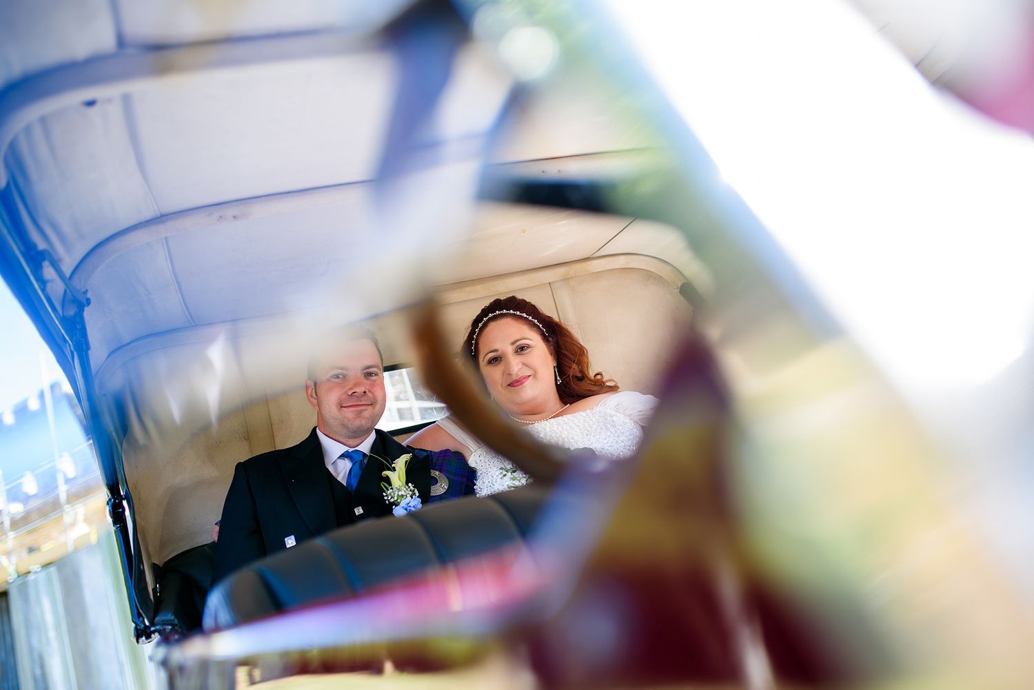 Wedding guests enjoying themselves in a bright indoor venue.