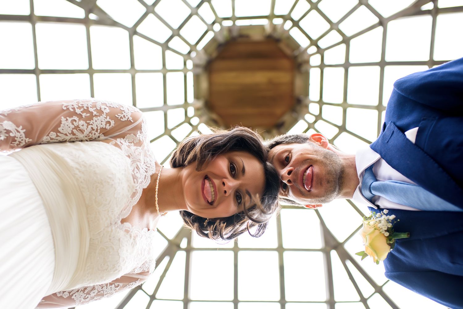 Looking up at geometric glass ceiling pattern in classical architectural setting.