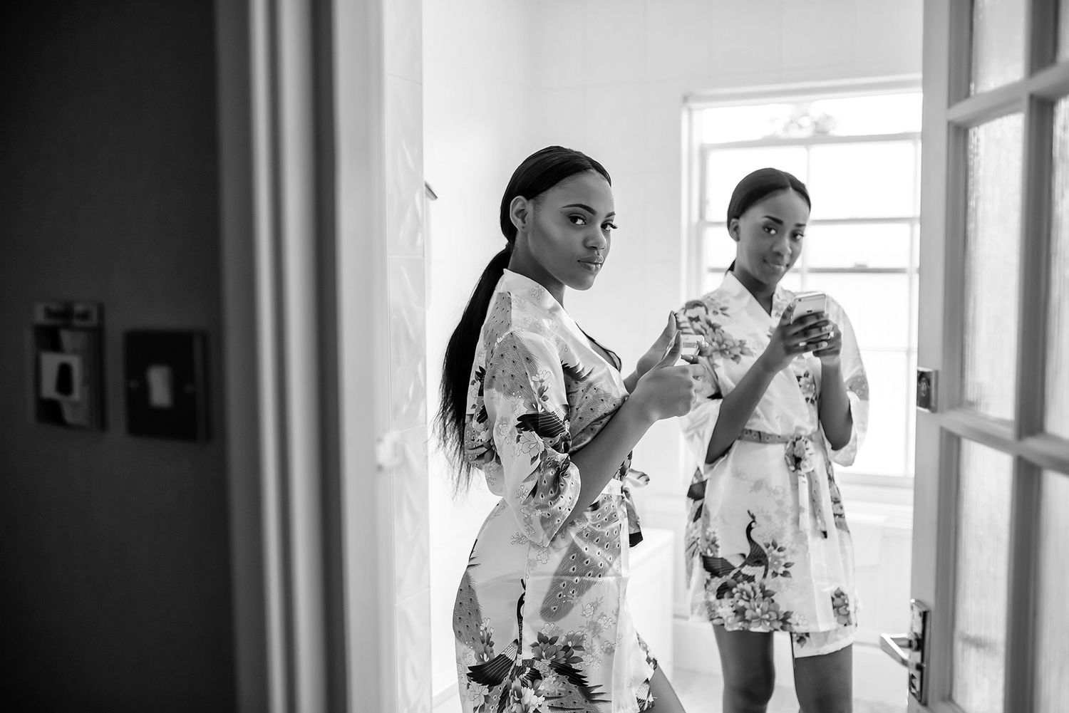 Indoor wedding preparation scene with natural window lighting.