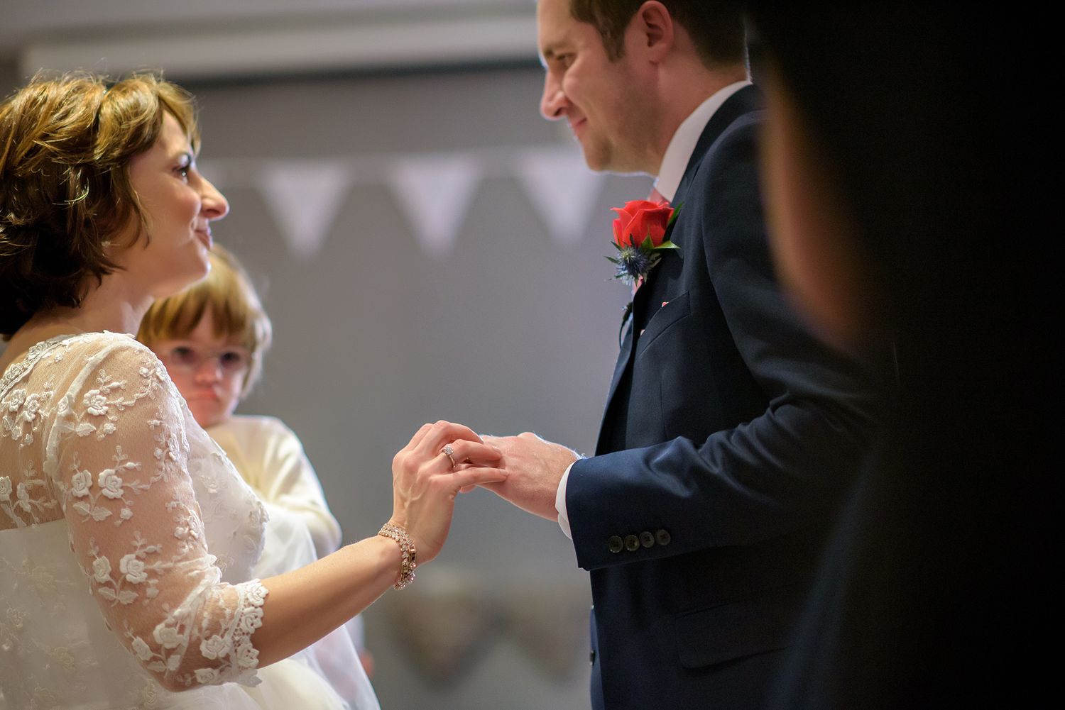 Wedding reception venue decorated with white lace and formal attire.