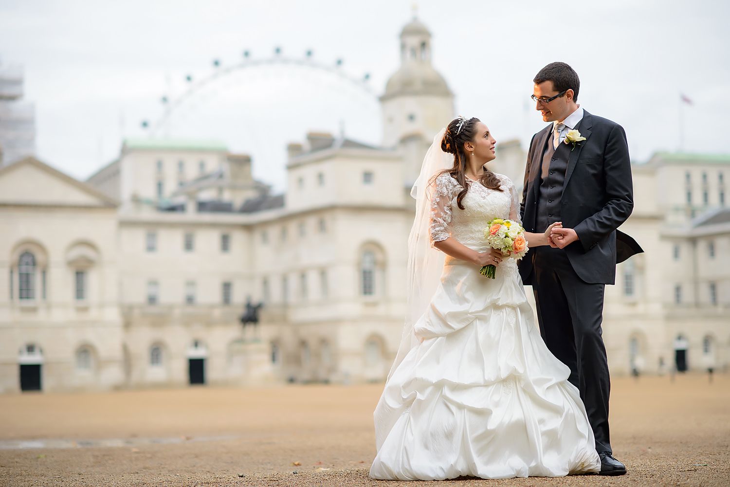 Couple poses for wedding photos in front of historic London landmarks including Horse Guards.
