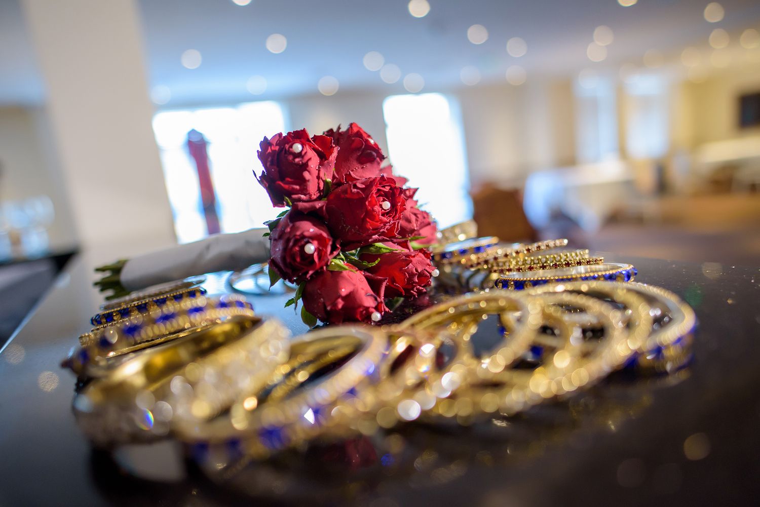 Close-up detail shot of ornate golden jewelry with red floral accents.