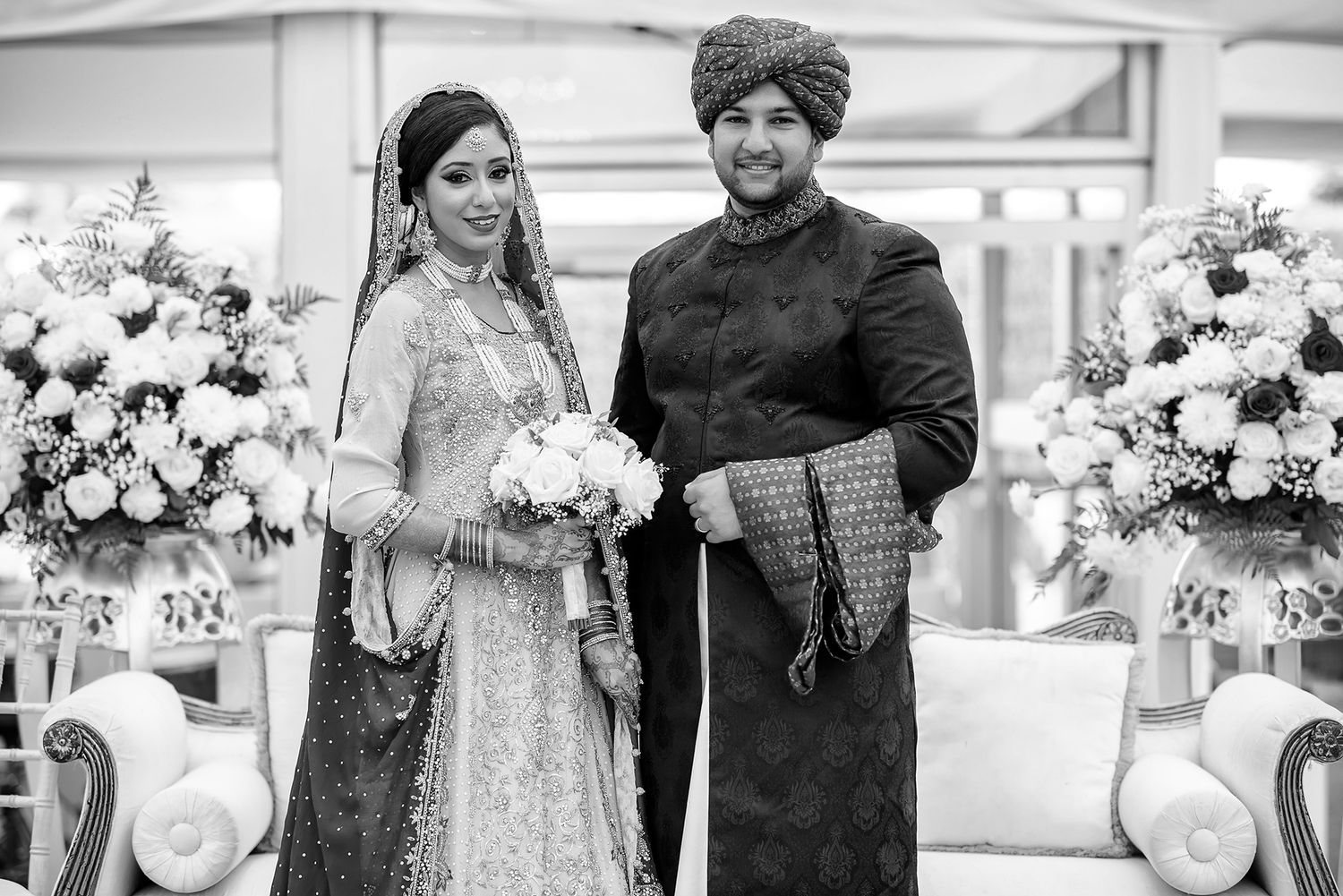 Black and white photo of elegant floral arrangements and wedding decor.