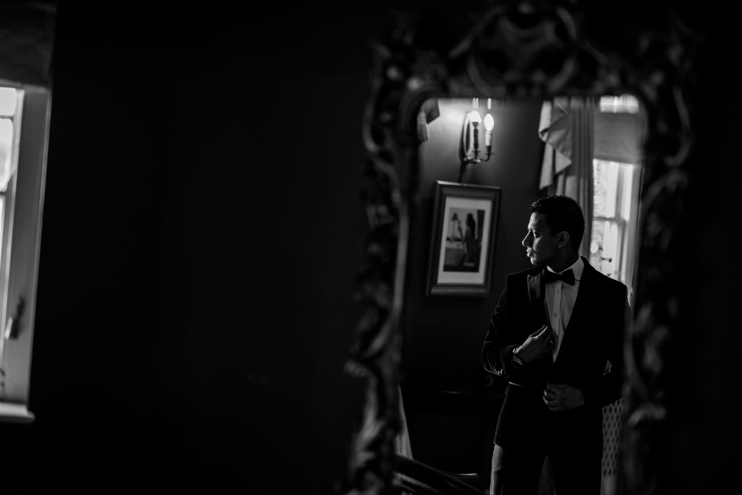 A moody black and white corridor interior with dramatic lighting and architectural details.