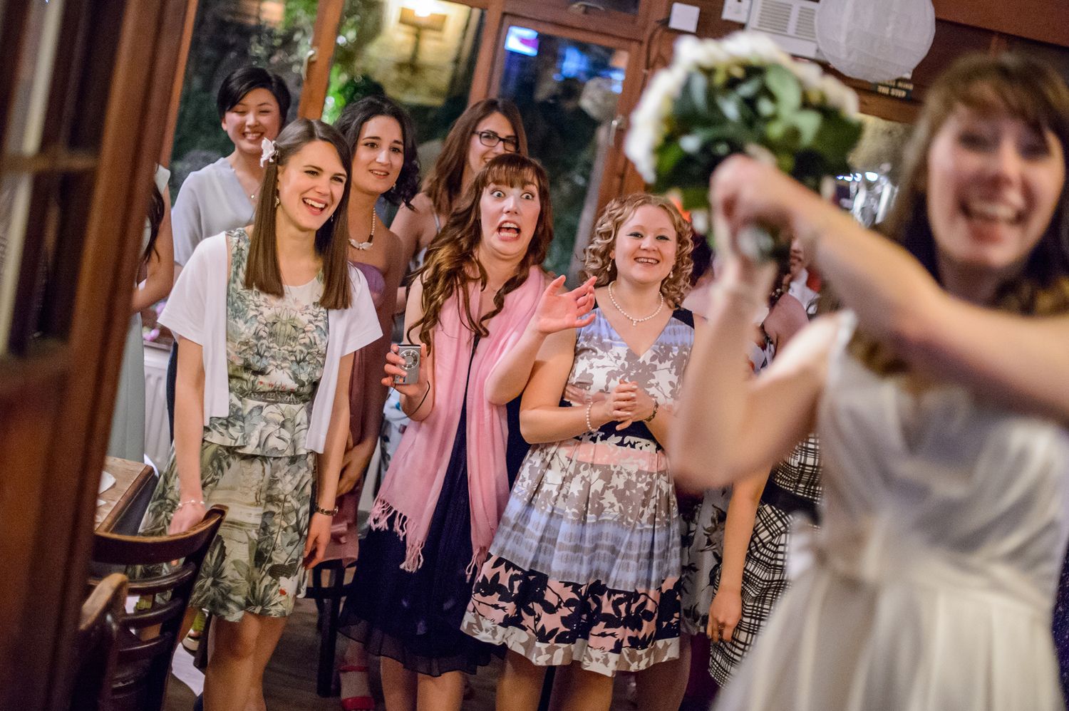 Wedding guests dancing and celebrating during reception party.